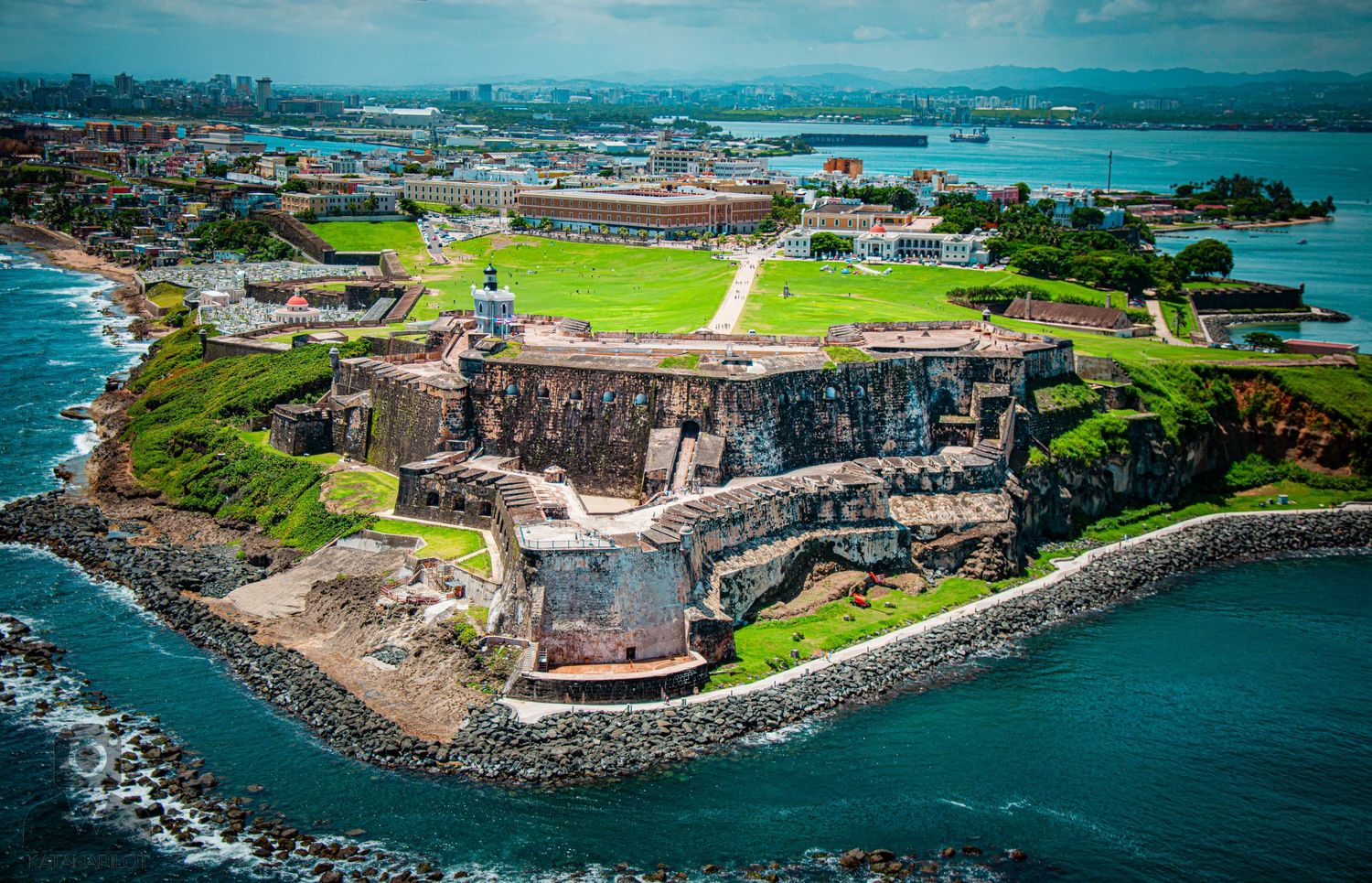 Historic coastal fortification complex with defensive walls and structures situated on a rocky peninsula.