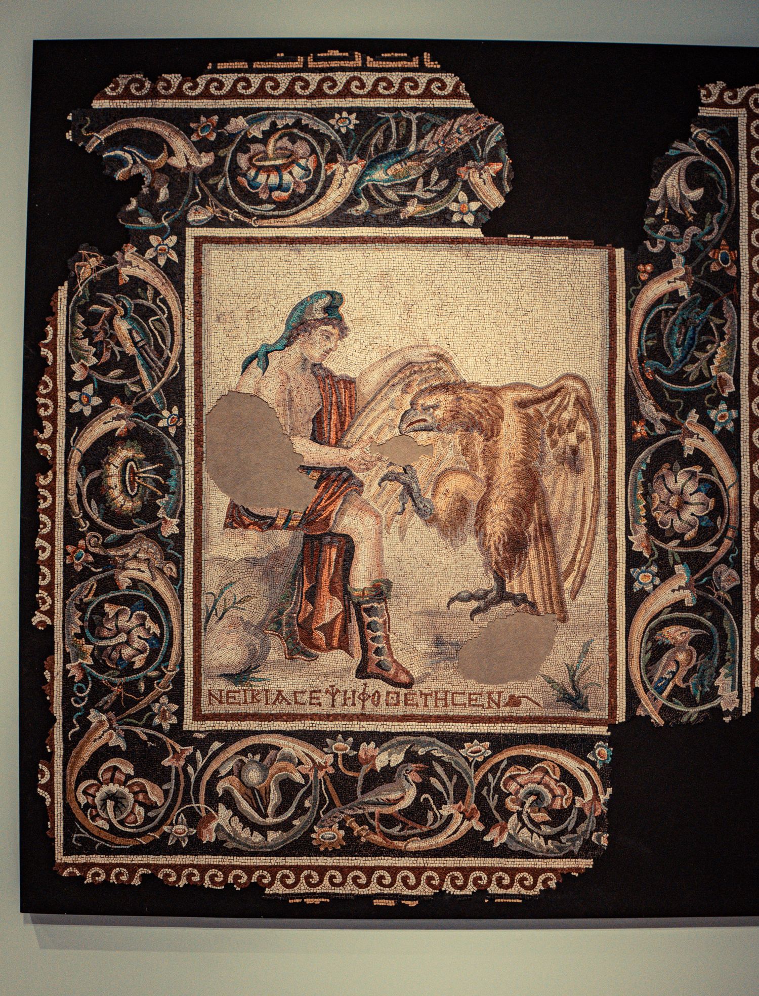 Ancient decorative friezes showing mythological scenes with ornate borders in sepia tones.