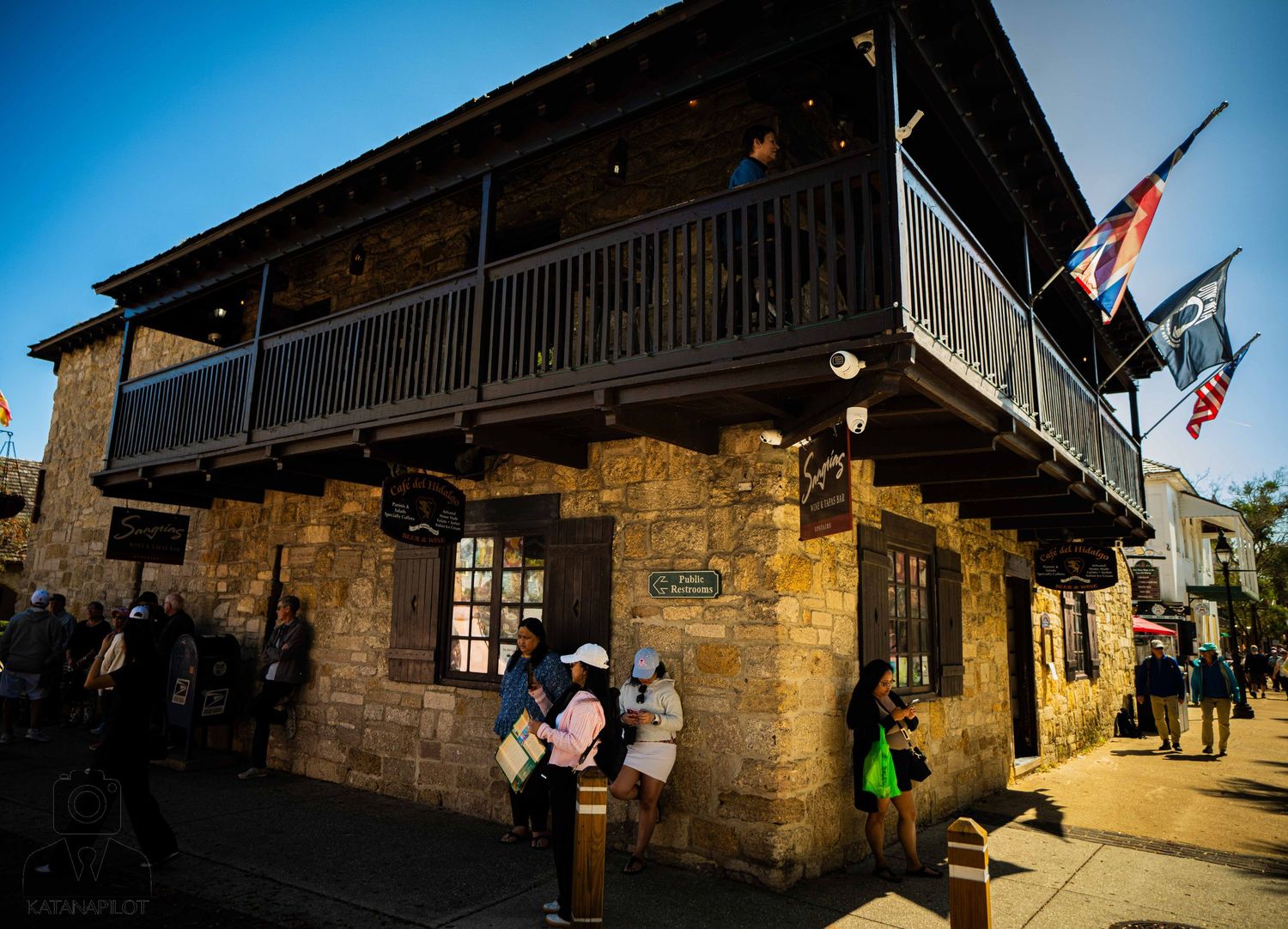 Stone buildings with rustic architecture and wooden balconies under bright blue skies in The Rocks, Sydney.