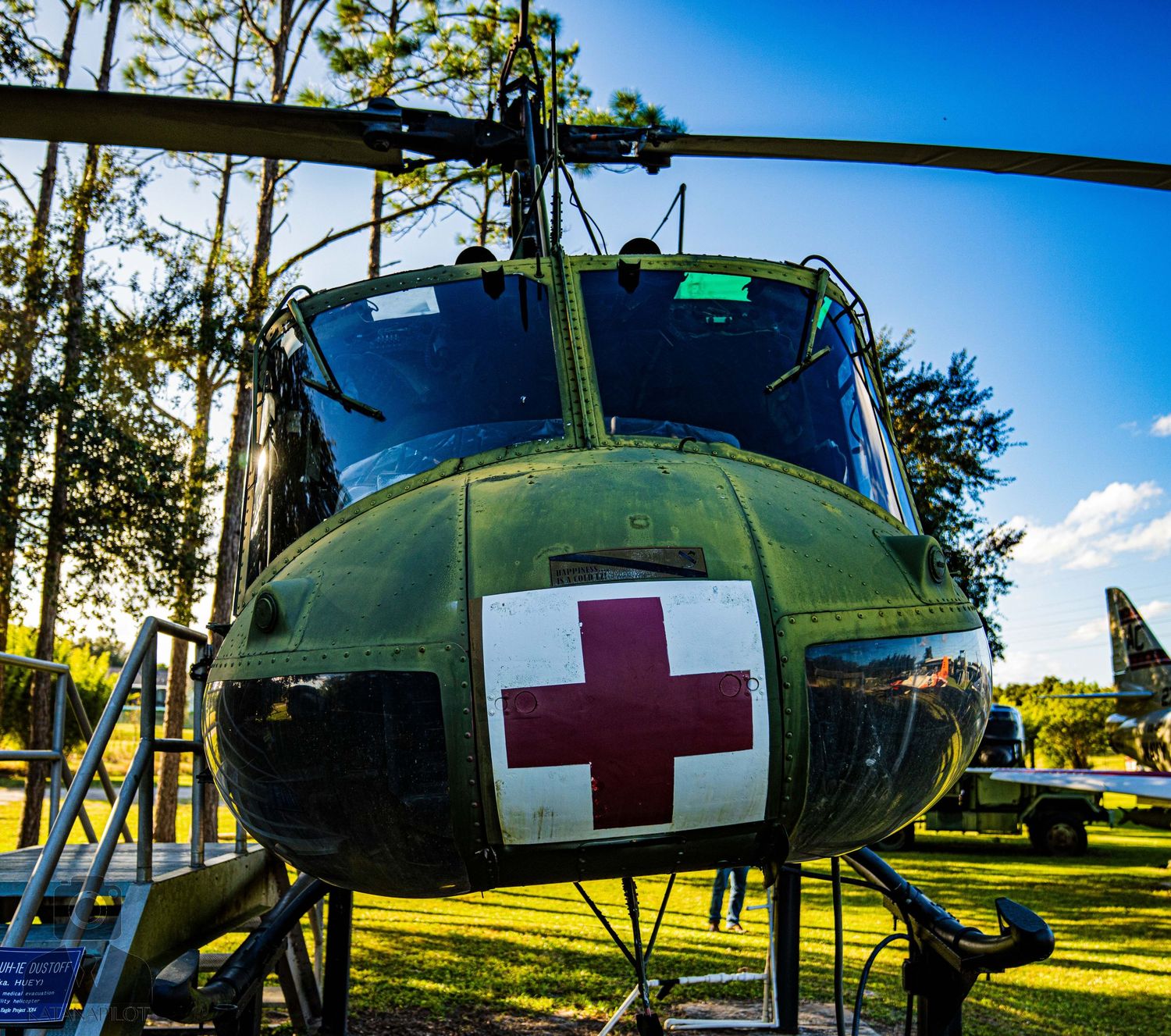 Military medical evacuation helicopter with red cross markings displayed at an outdoor museum.