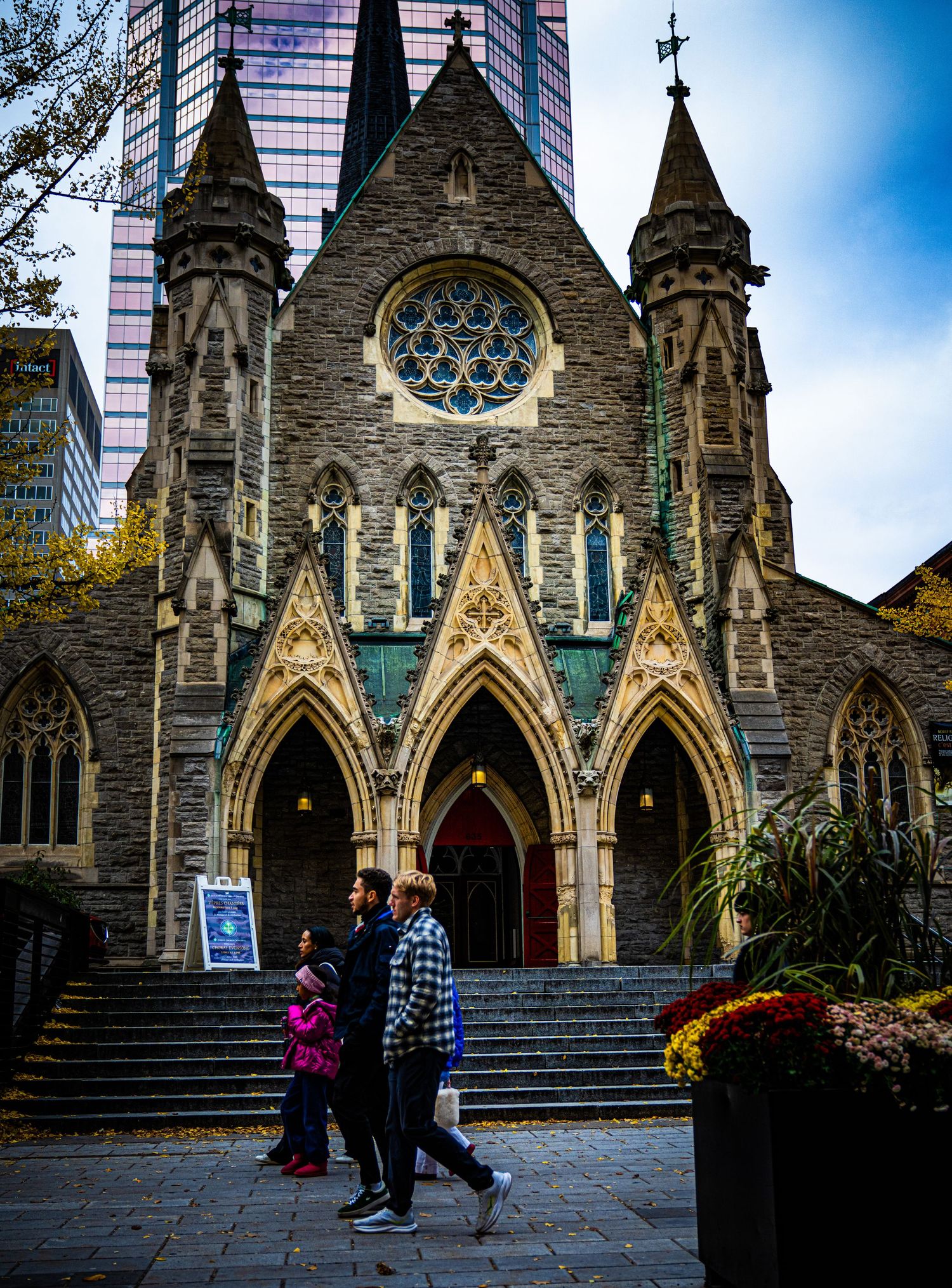 Gothic stone church facade with multiple arched entrances and ornate architectural details.