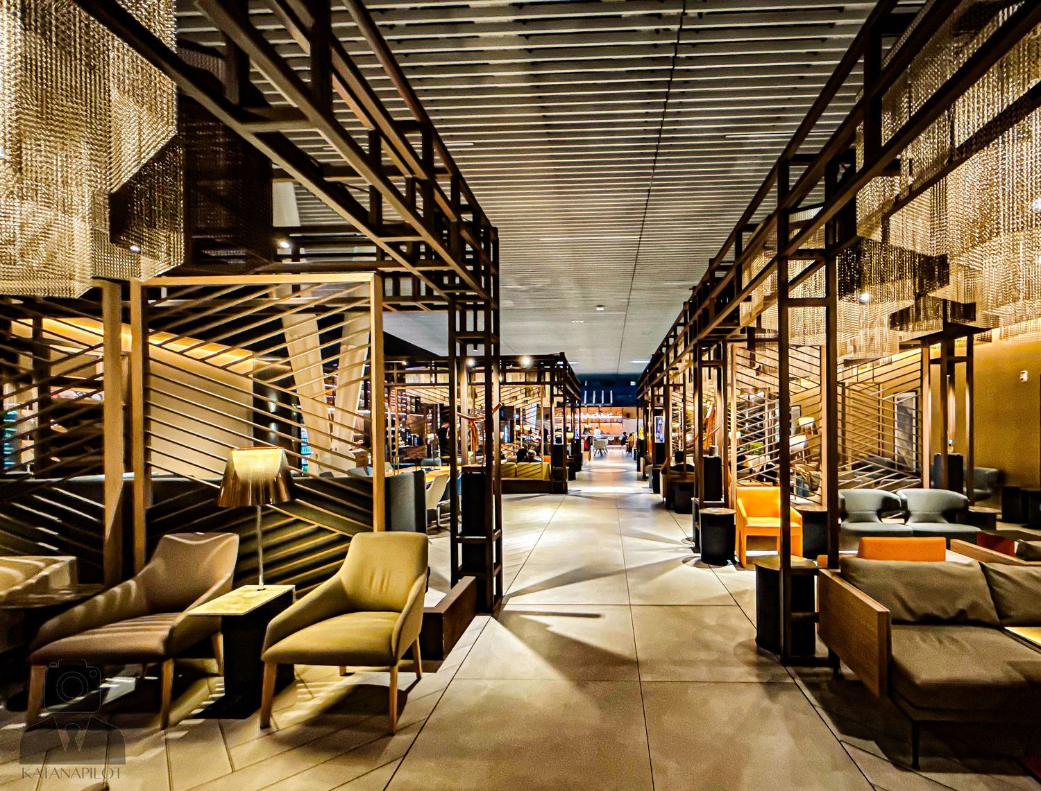 Long corridor with modern architectural elements and dramatic lighting design.