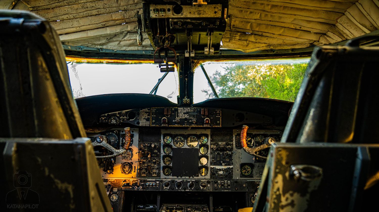 Vintage aircraft cockpit dashboard showing old gauges and controls.