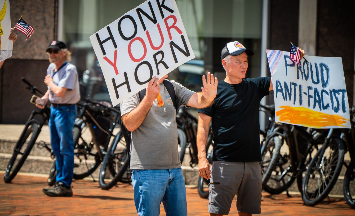 A line of people with protest signs and wheelchairs gather for a disability rights demonstration.