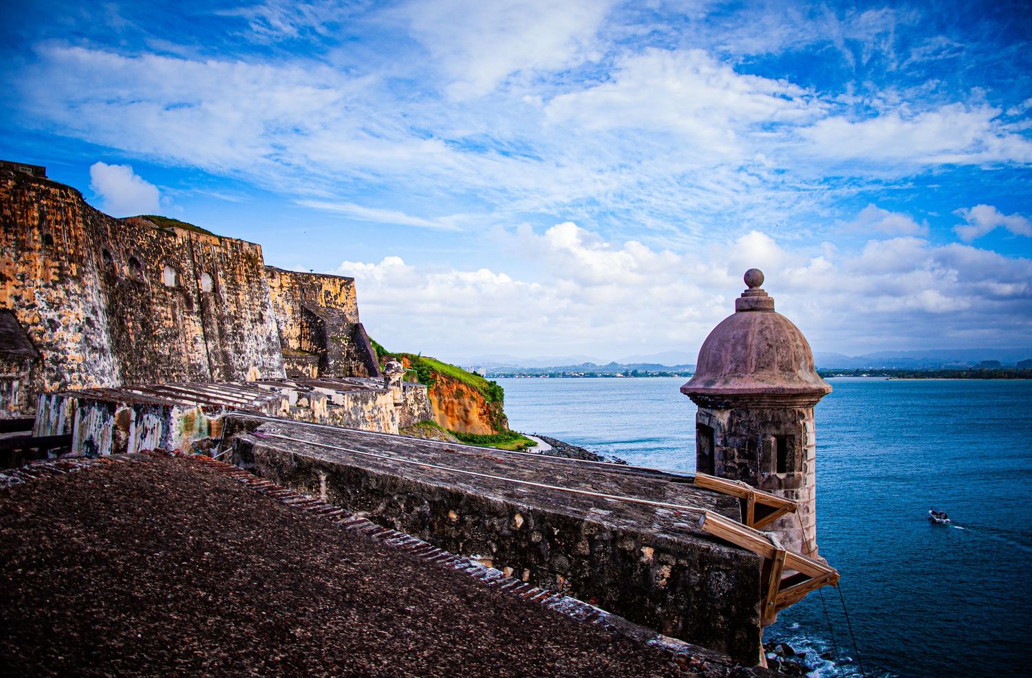 Historic stone sentry tower overlooks the Caribbean Sea from atop cliffs at El Morro fortress in San Juan, Puerto Rico.
