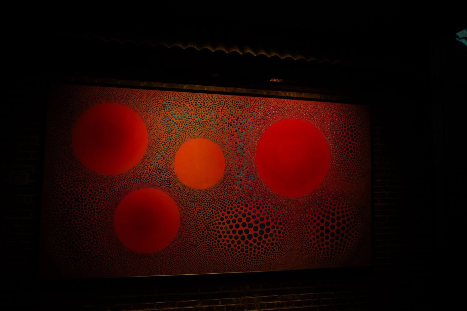 Abstract red and black background with circular bokeh lights and textured patterns creating a moody atmosphere.