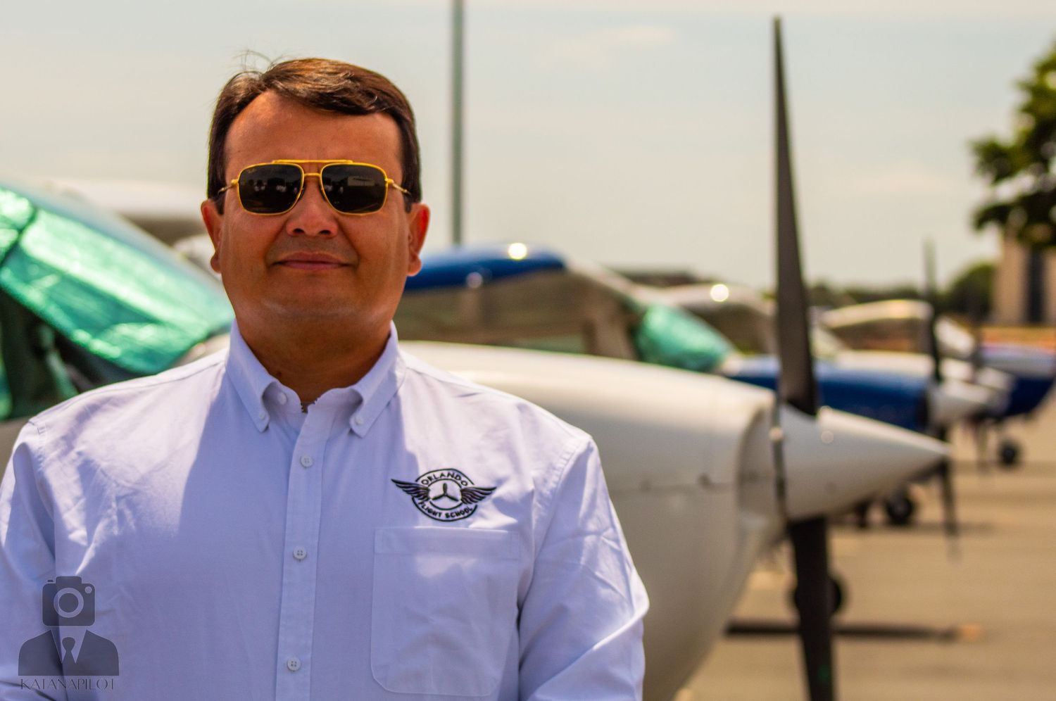 Aviation team members on sunny tarmac with planes in background.