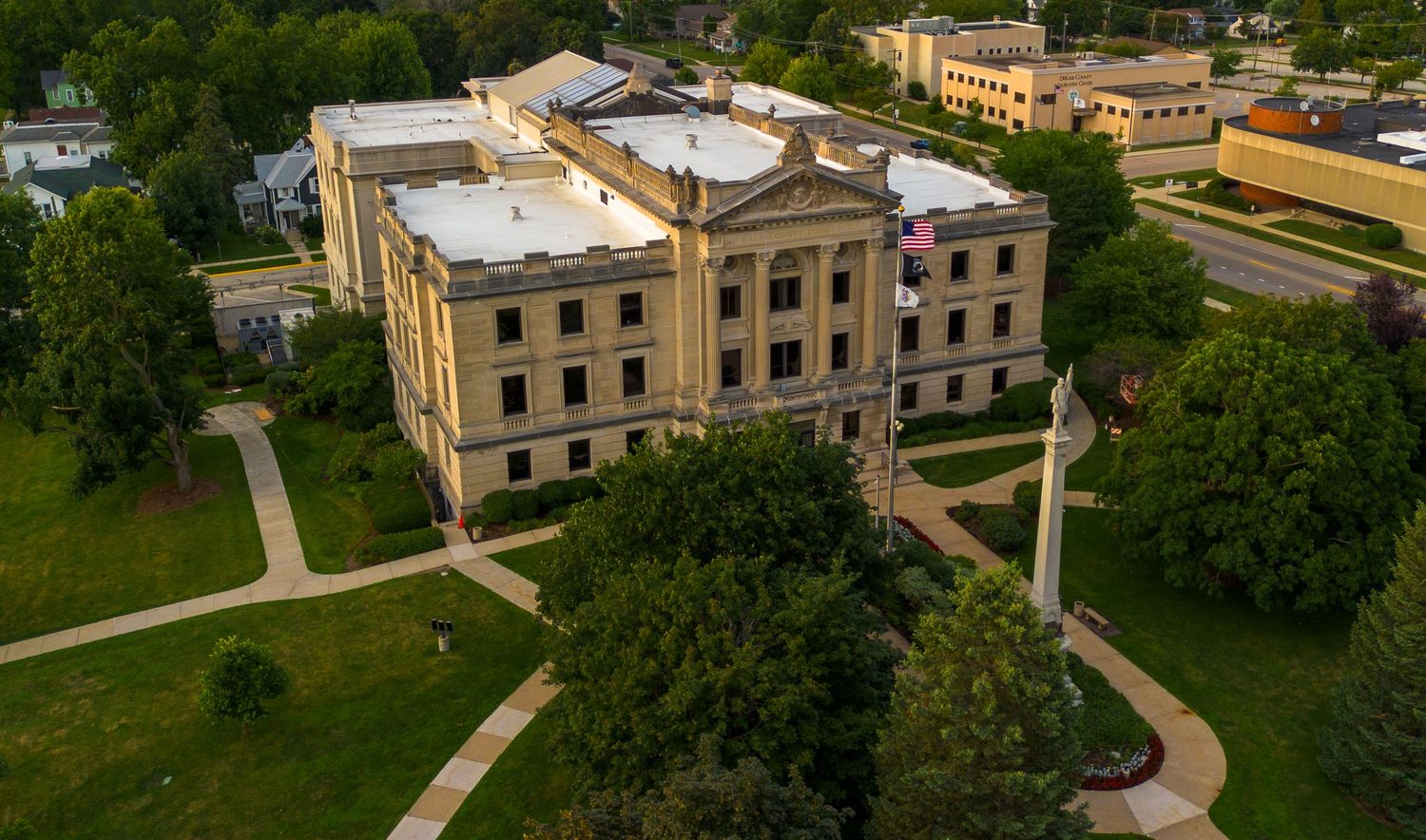 Aerial view of historic brick buildings and winding paths on a university or institutional campus.