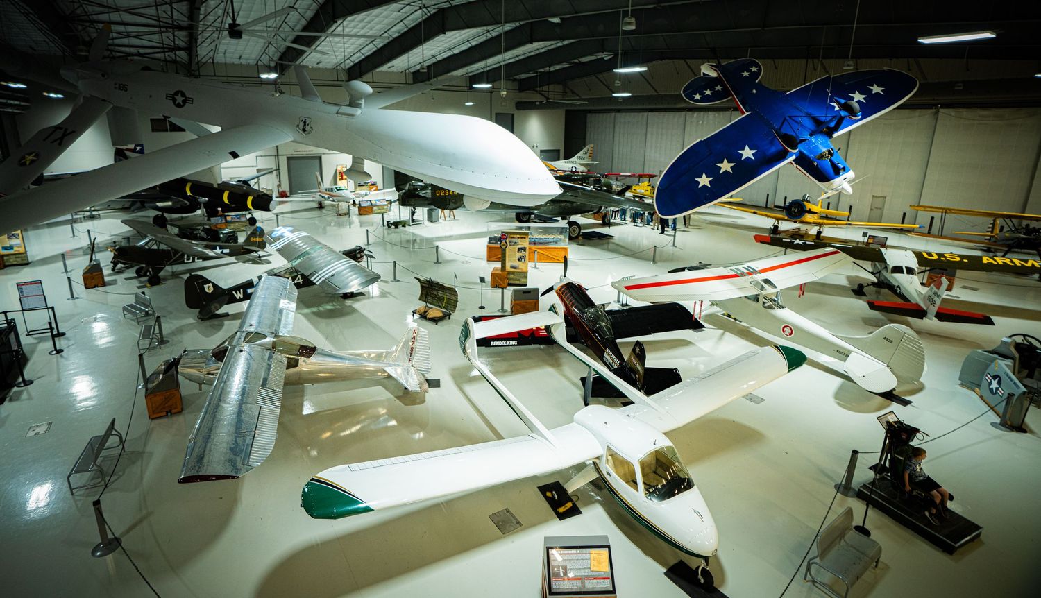 Aviation museum interior showcasing multiple historic aircraft and planes on display in a large hangar facility.