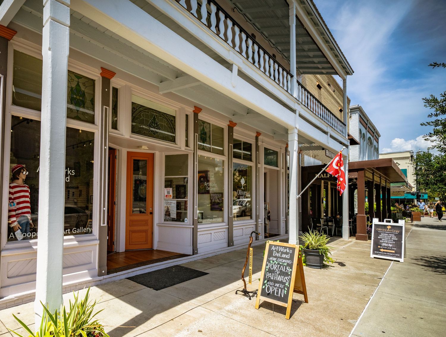 Historic downtown Sanford Florida storefront with white columns and covered walkway on a sunny day.