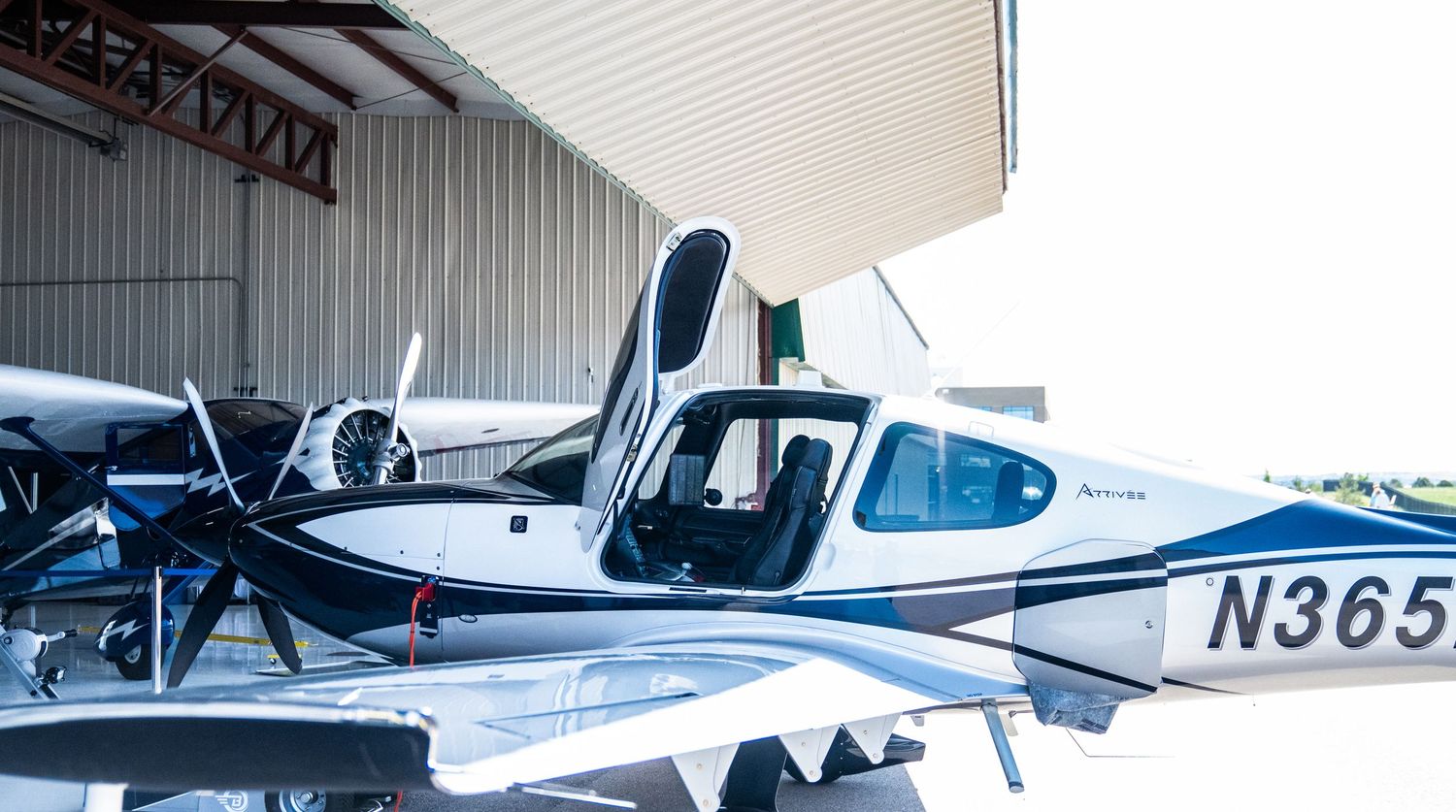 Line of small private aircraft parked at airport terminal.