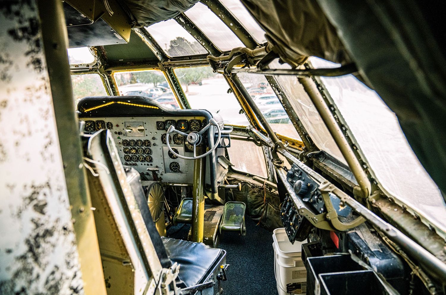 Interior view of a commercial aircraft cockpit showing flight instruments and controls in low light conditions.