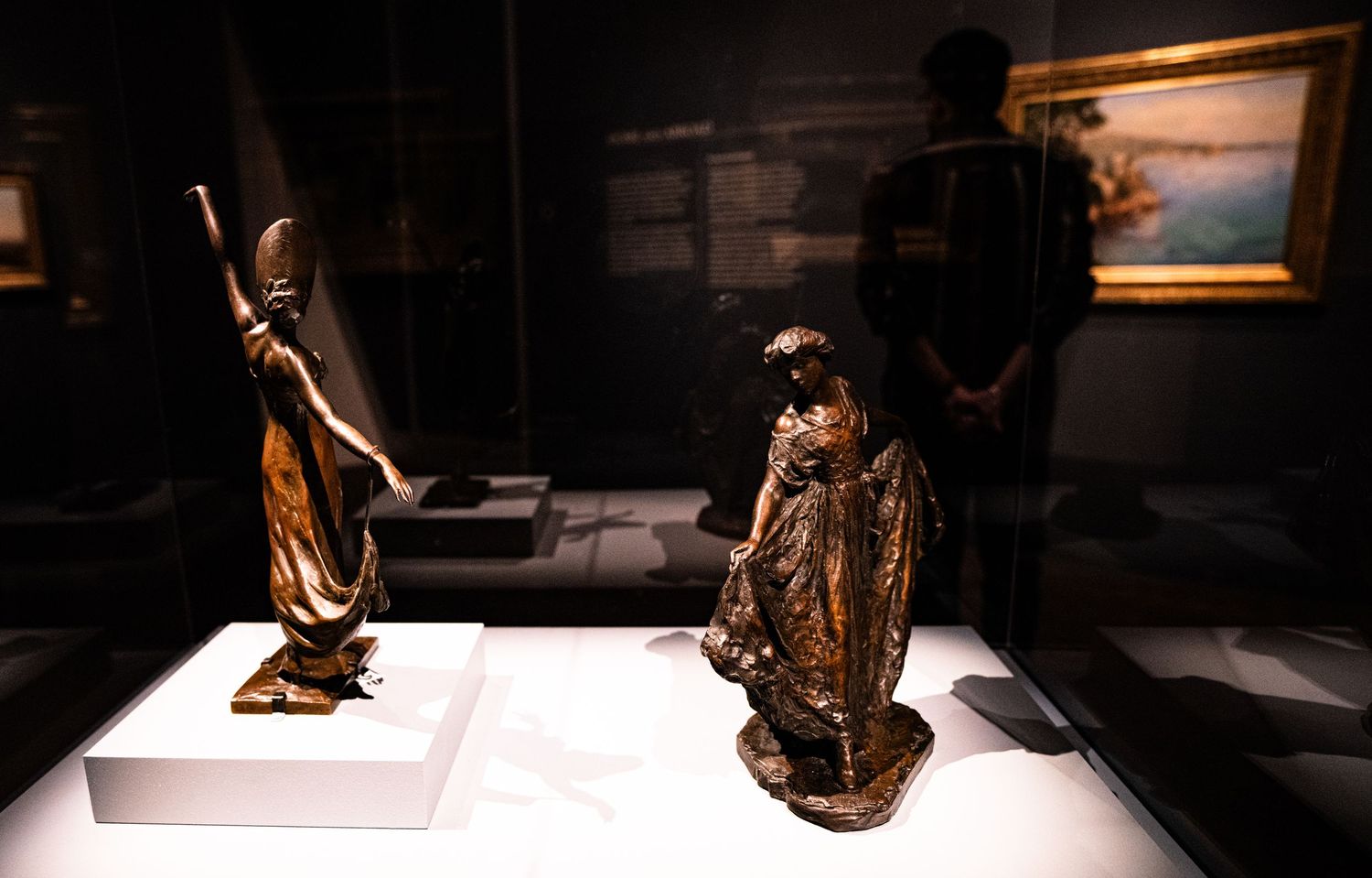 Ancient Egyptian artifacts and sculptures displayed in a dimly lit museum gallery with dramatic lighting effects.