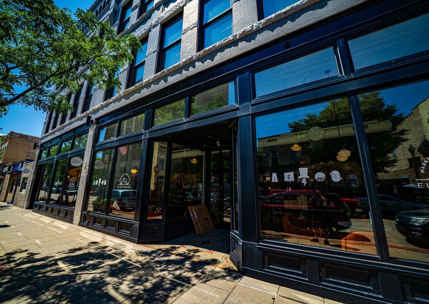 Historic brick building with large storefront windows and classic architectural details.