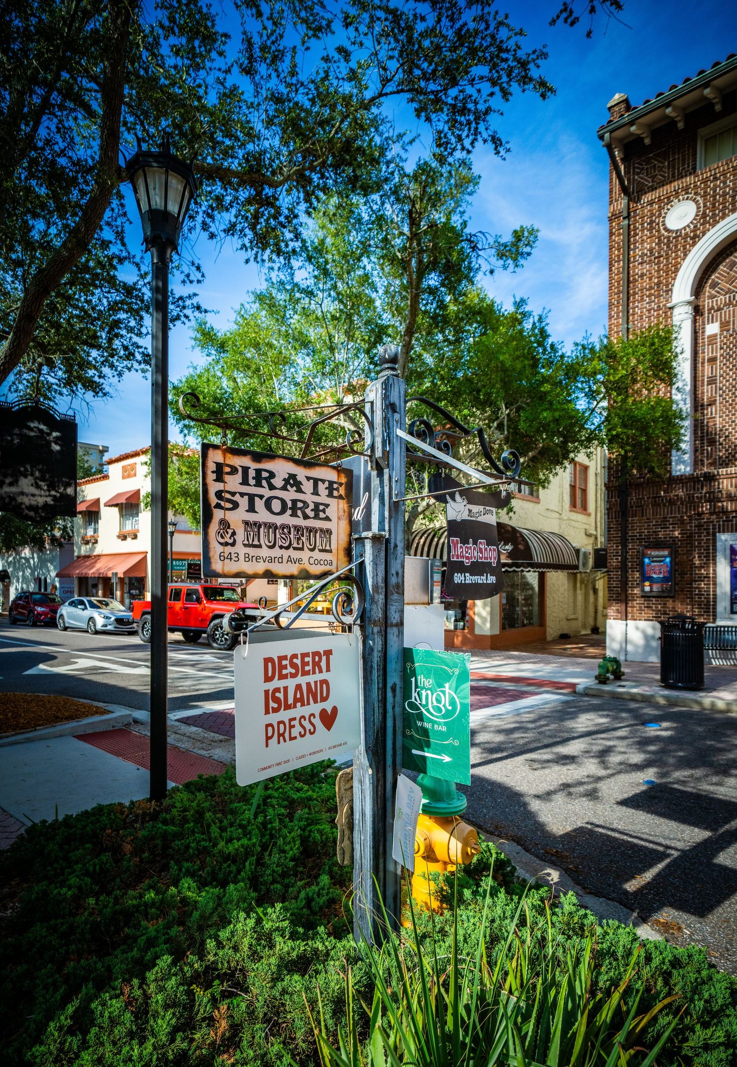 Street corner with vintage signage for Desert Island Press and traditional lamp post.