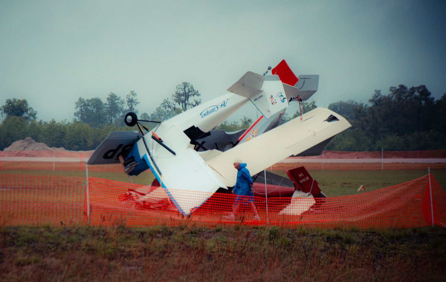 A sequence of photos showing a small aircraft crash landing and flipping over in a grassy field.