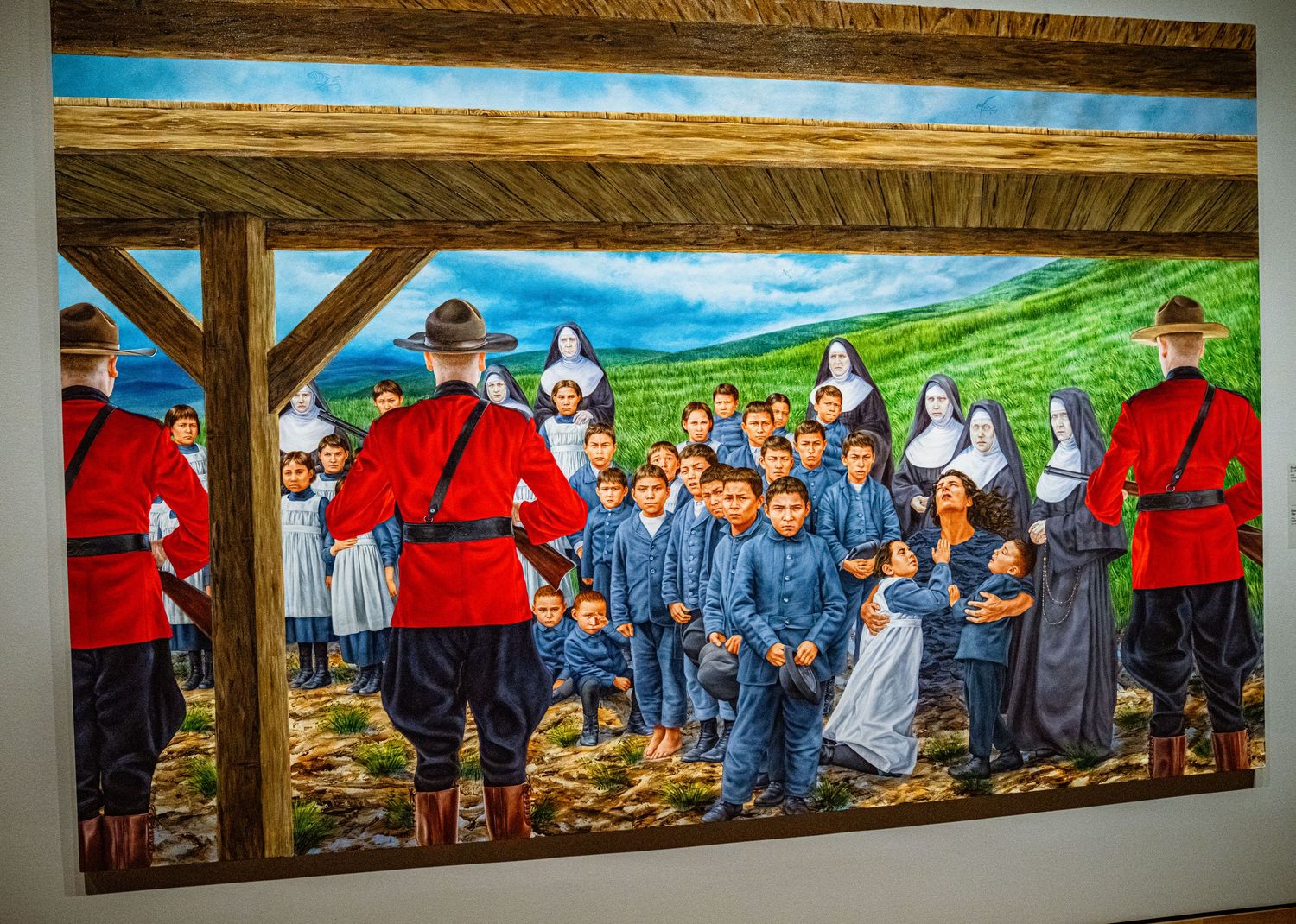 A long panoramic mural depicting a rural community gathering with people in traditional clothing against a vibrant landscape.