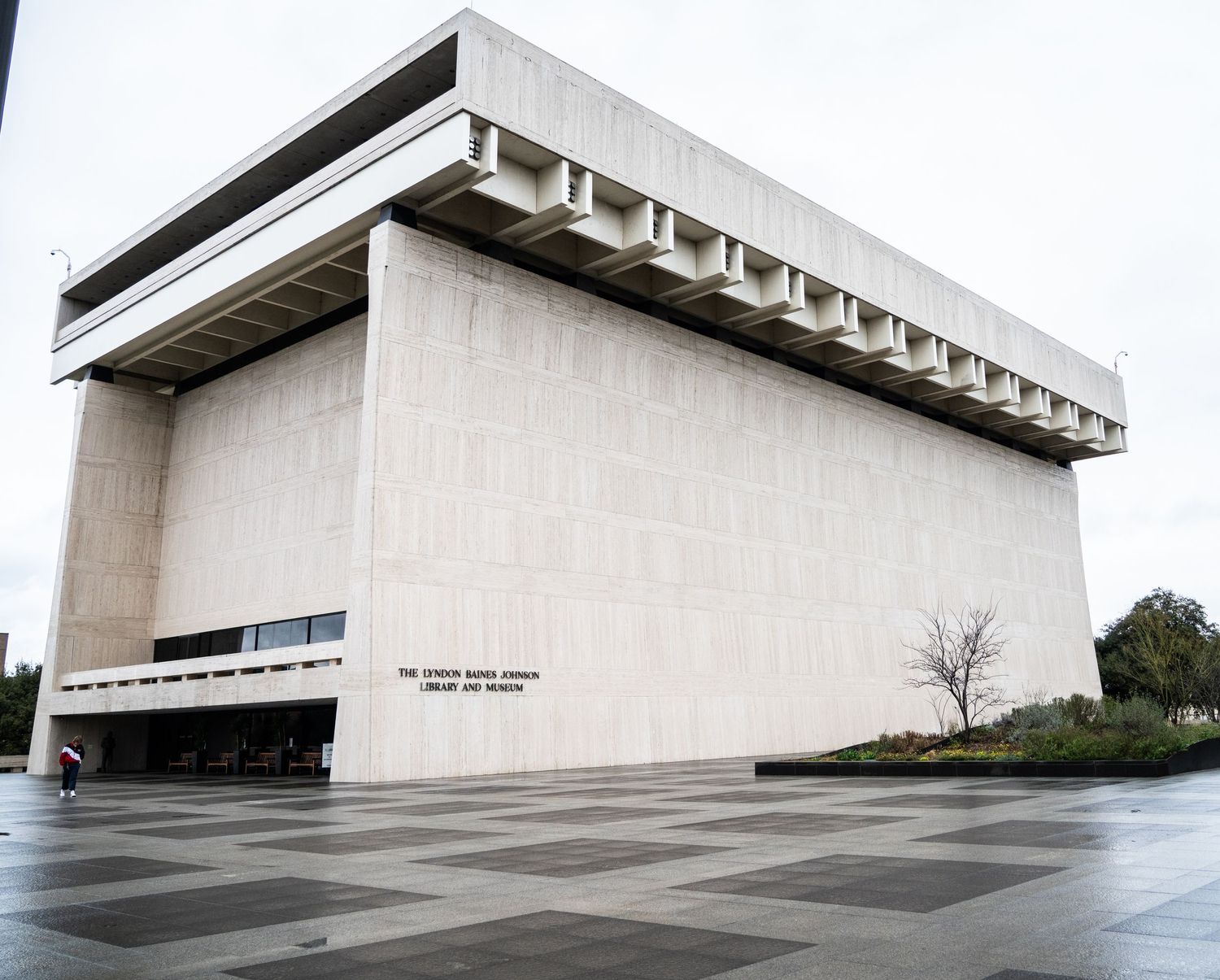 Series of minimalist concrete buildings with sloped walls and geometric architecture.
