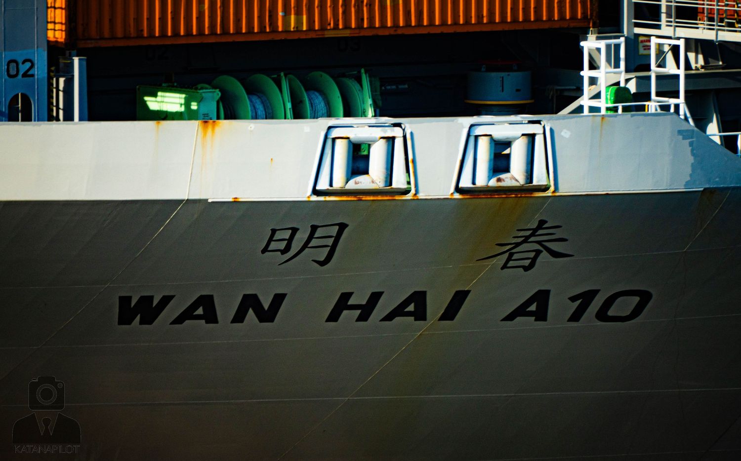 Close-up view of a ship's hull showing 'WAN HAI A10' text painted in white against a dark background.