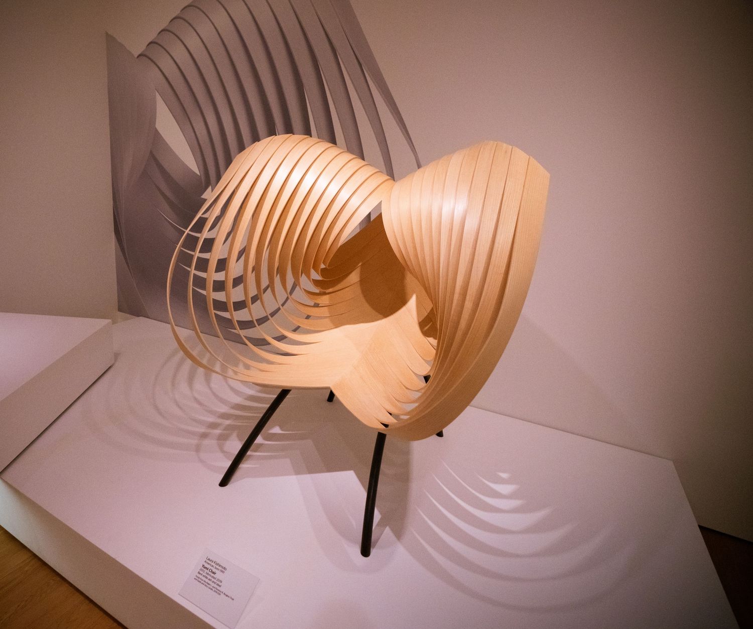 Series of photos showing a spiral wooden lamp casting geometric shadows on white surface.