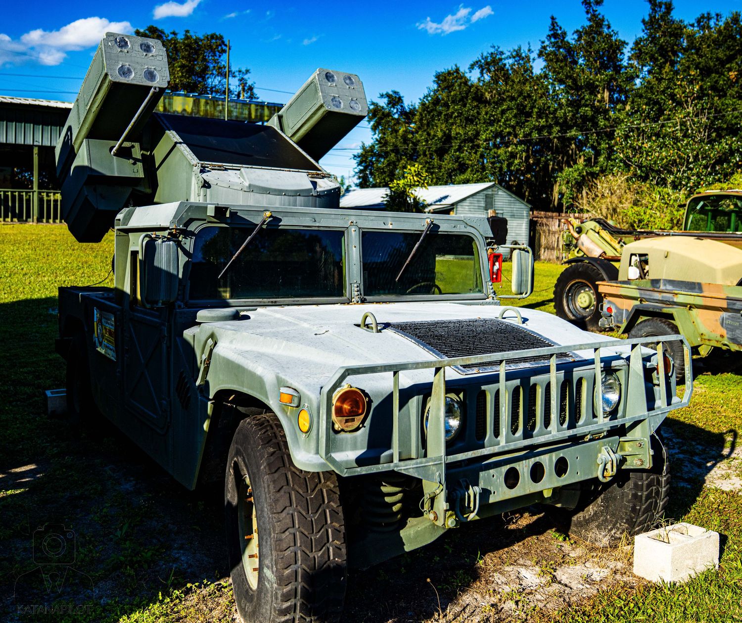 Military vehicles including Humvees and armored carriers displayed in an outdoor setting.