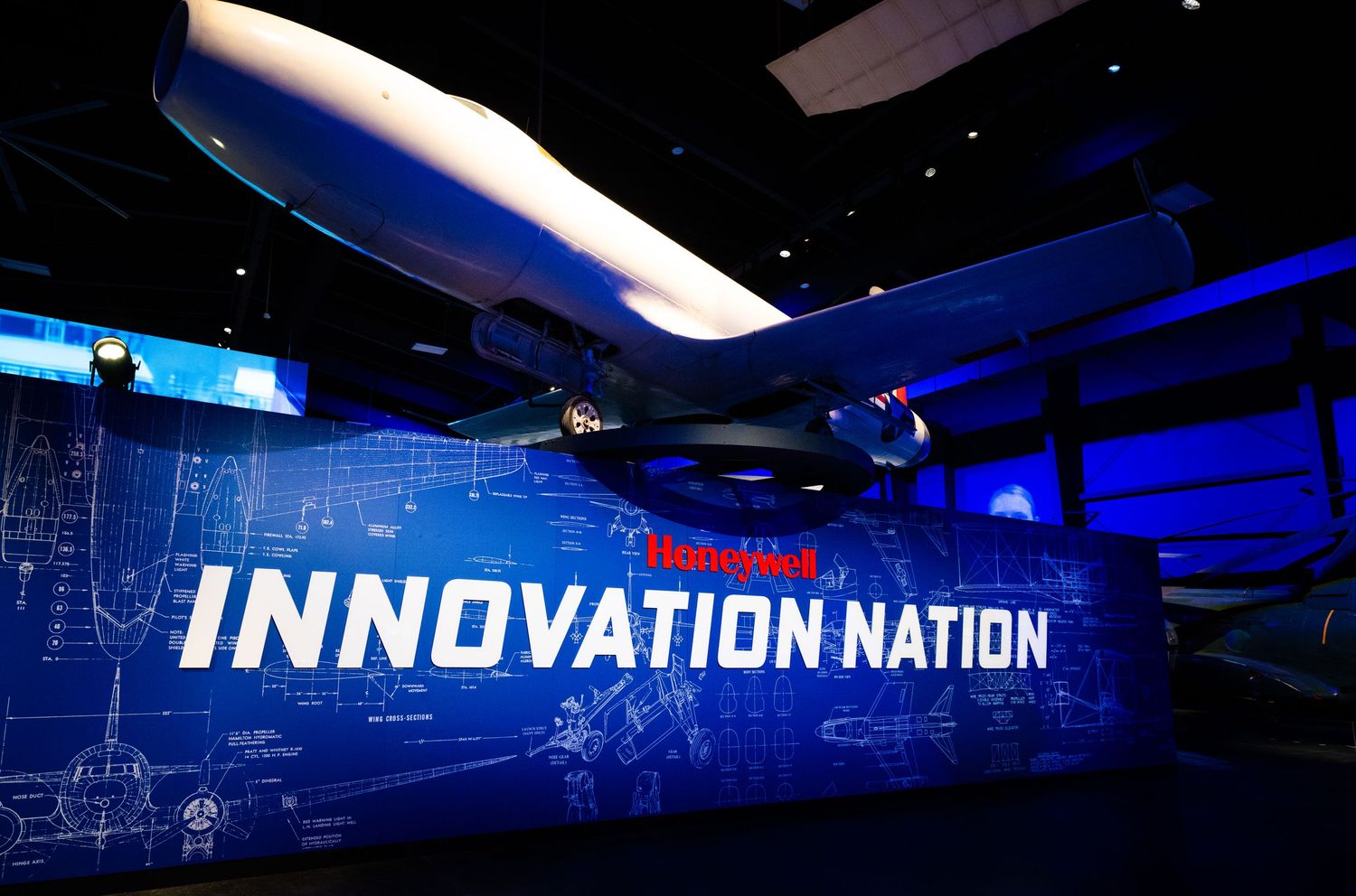 Museum exhibit hall with blue lighting and 'Innovation Nation' text display.