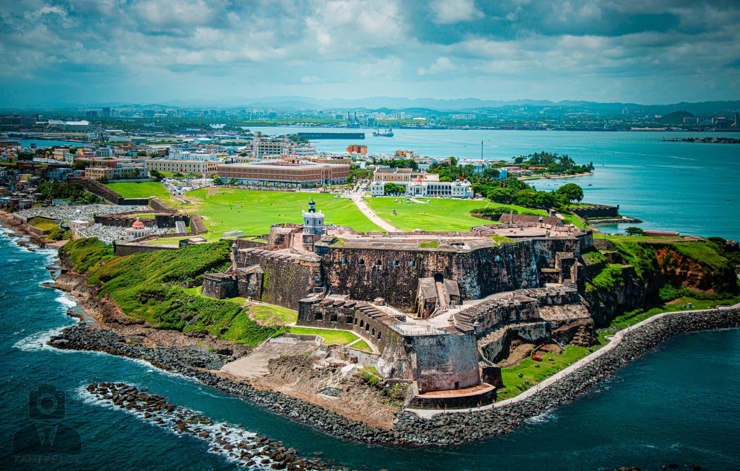 Wide-angle aerial shot of a historic coastal defense structure with surrounding ocean views.