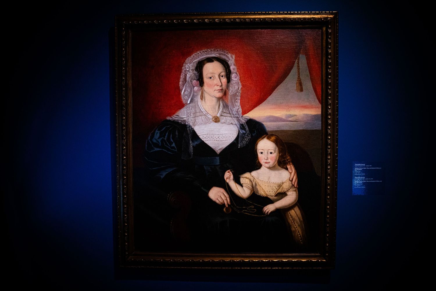 Series of classical portrait paintings exhibited in ornate frames with dramatic lighting.