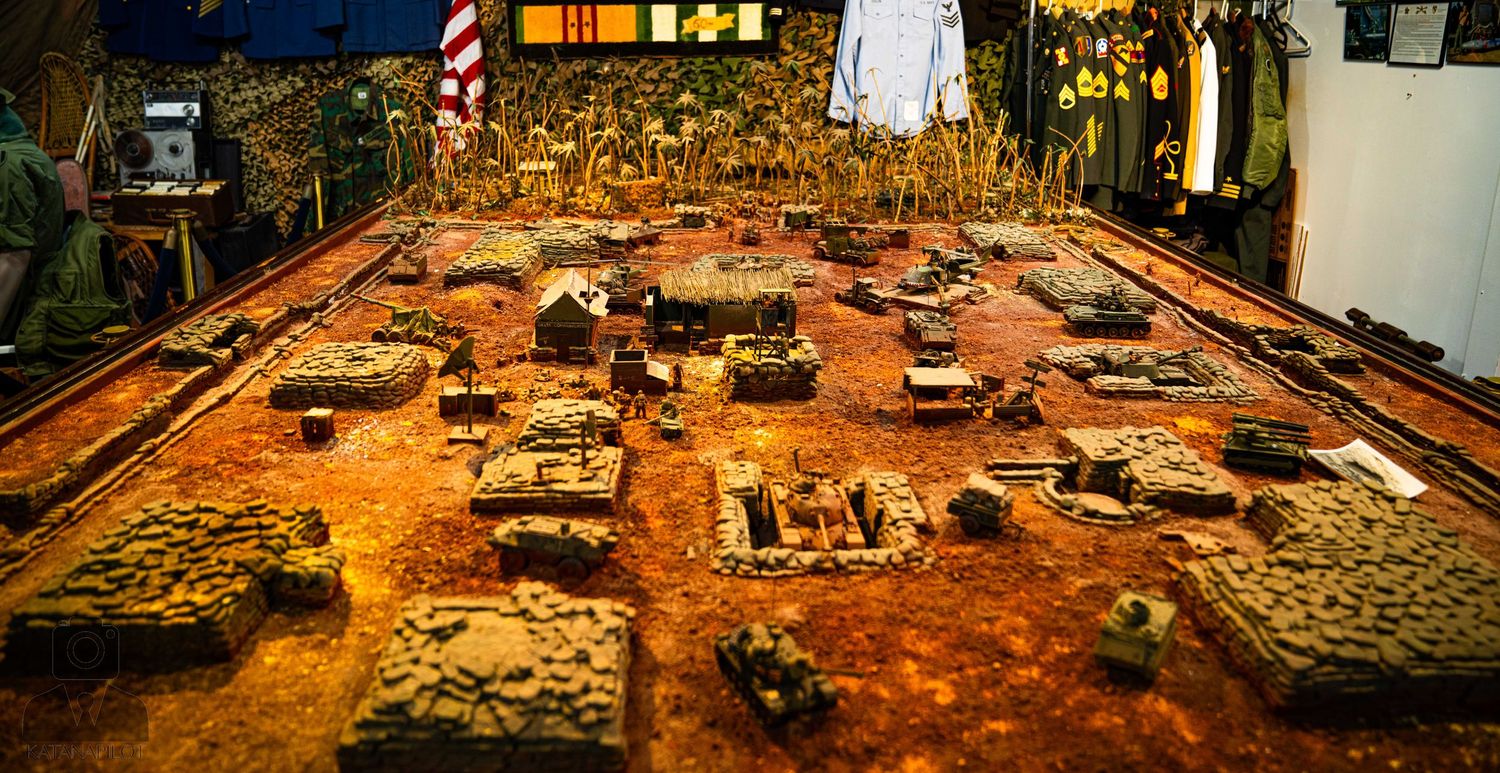 Rustic aviation museum interior with historic artifacts and American flag on display.