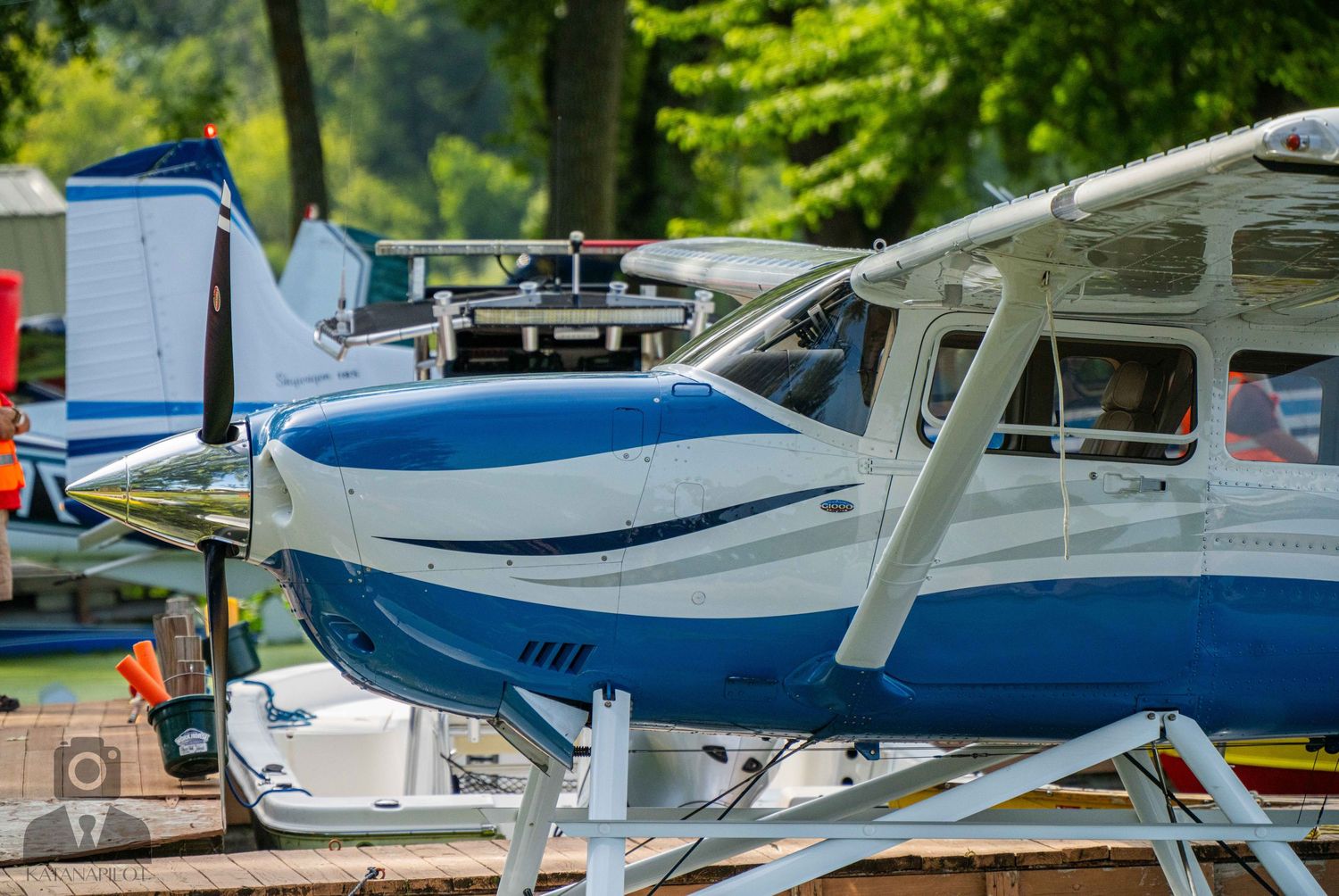 Close-up view of blue and white Cessna aircraft nose and propeller.