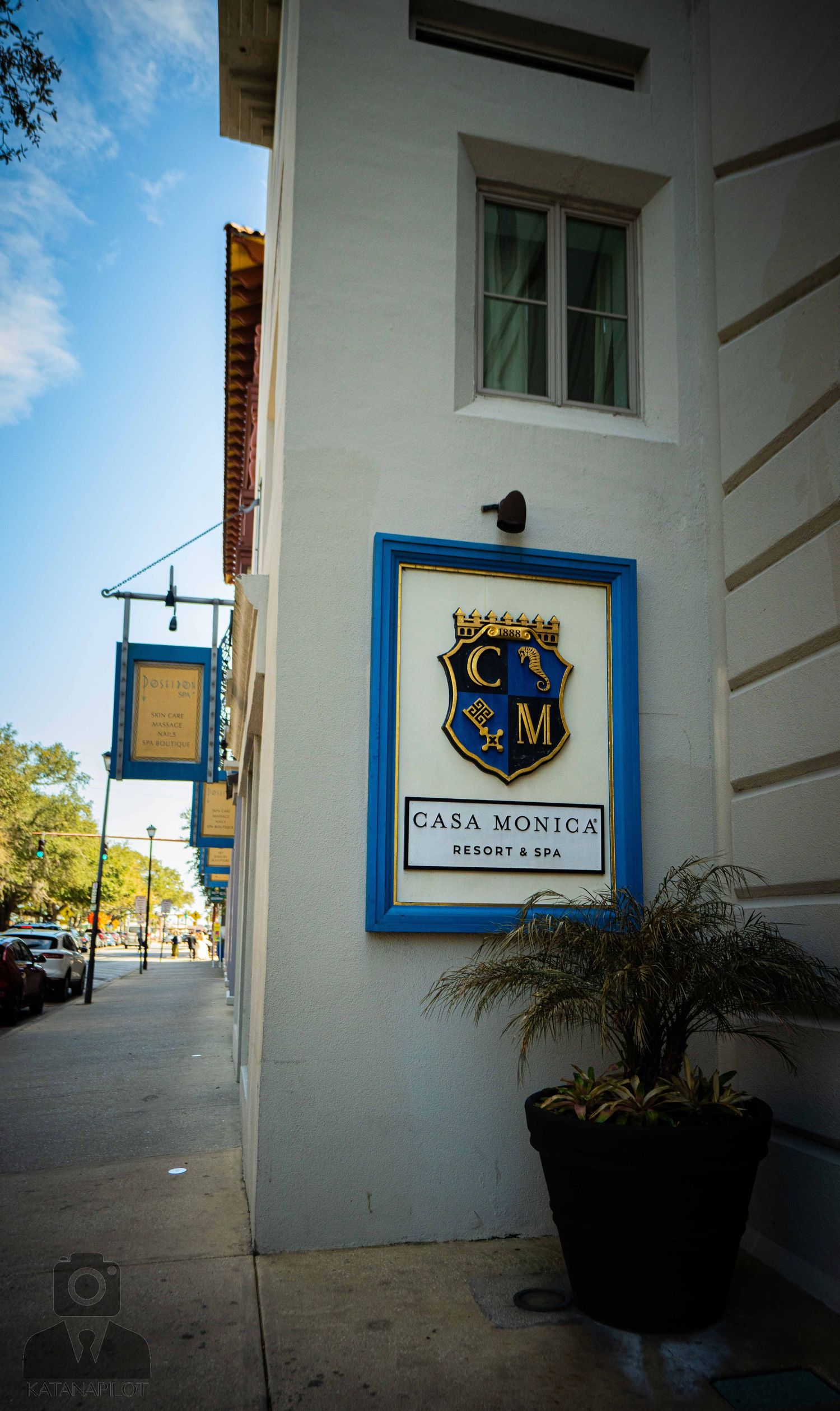 Three exterior shots of a white building with blue trim showing Casa Monica Resort & Spa signage and branding details.