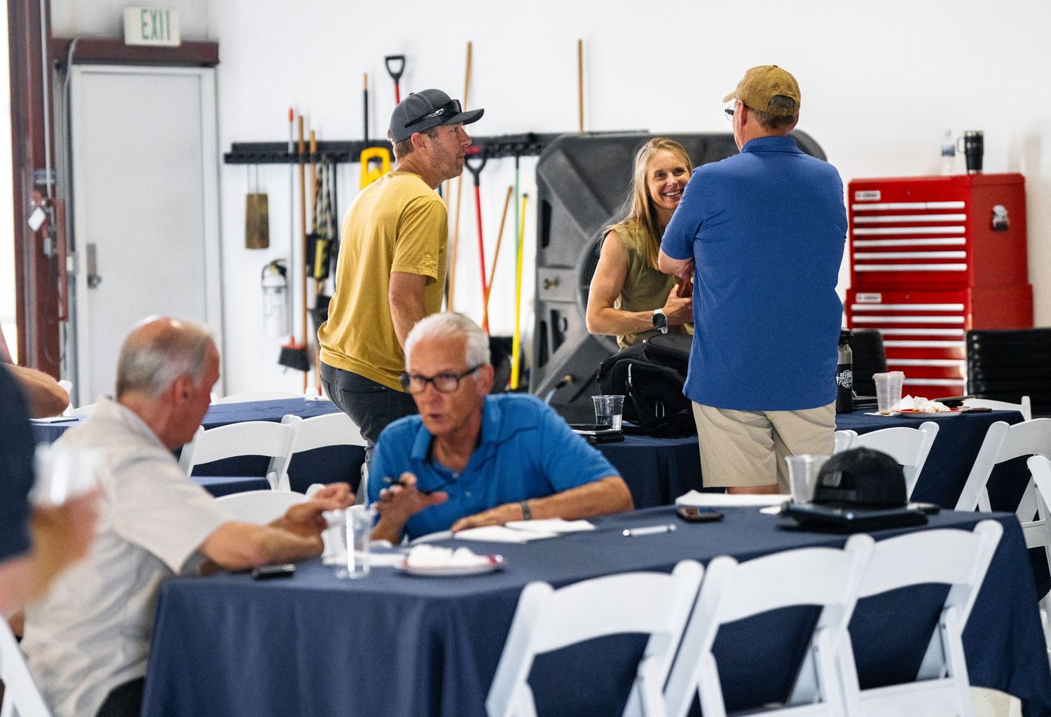 Aviation classroom with students seated at tables using training equipment and materials.