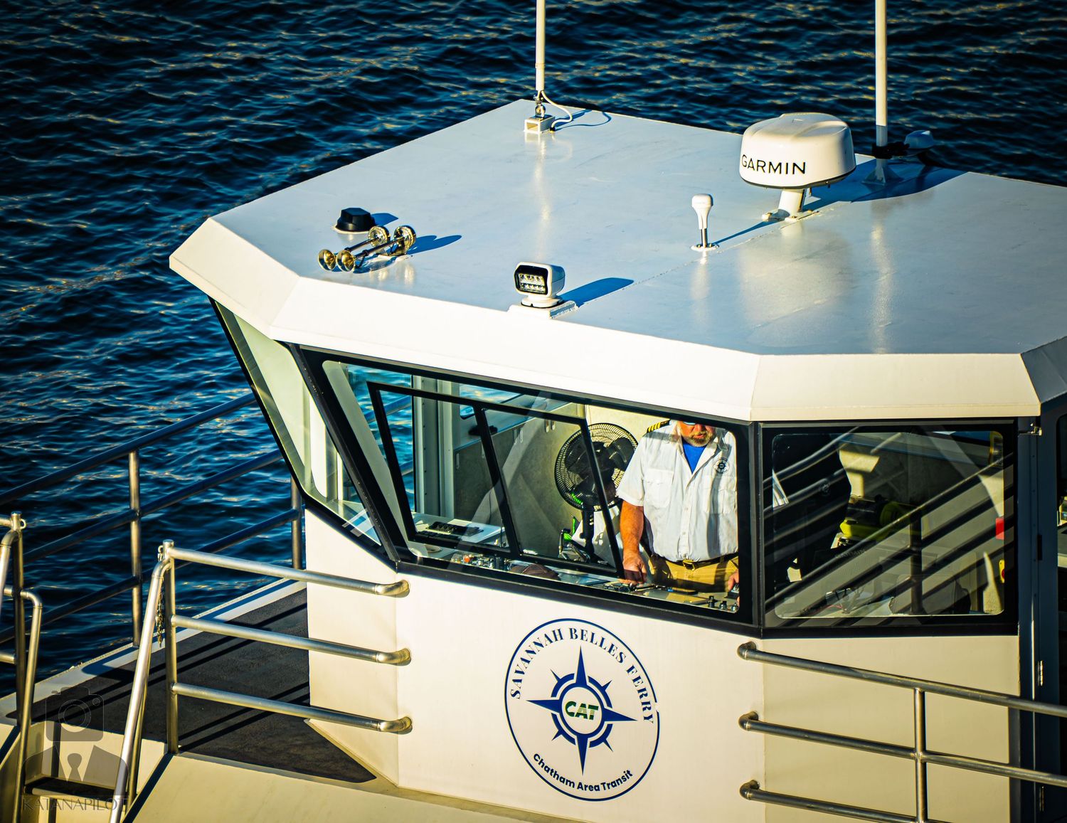 Pilot boats with compass logo emblems docked at a marina during daytime.
