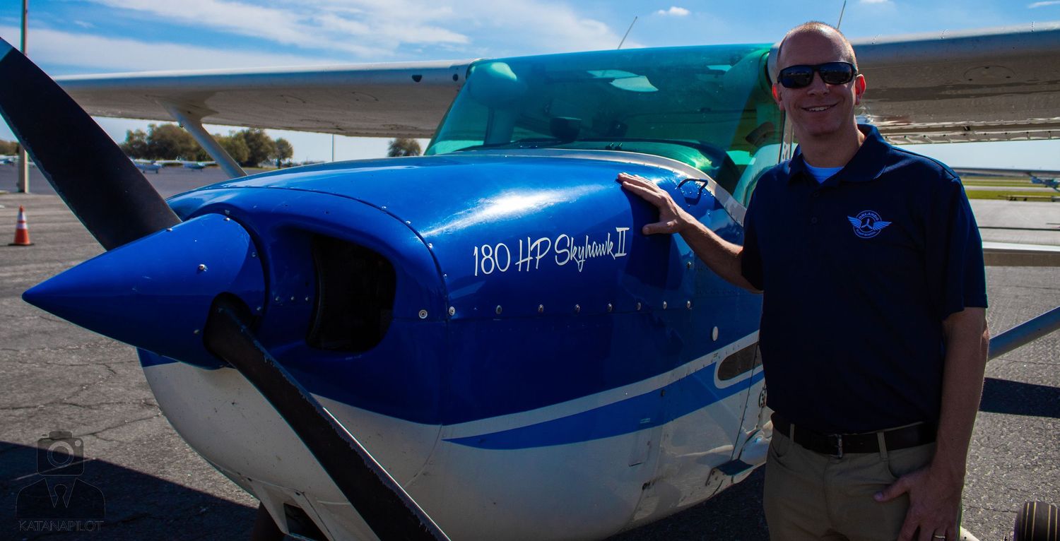 Small private aircraft with blue and white paint scheme on runway.