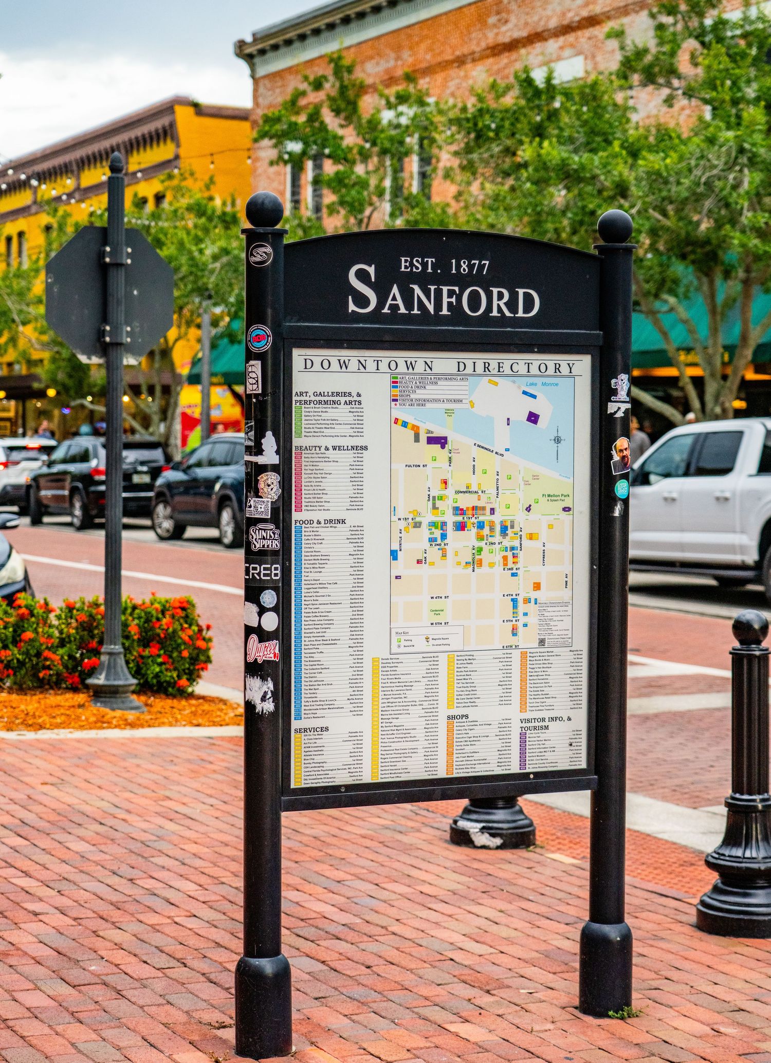 Row of black directory signs displaying Sanford business district maps and information.
