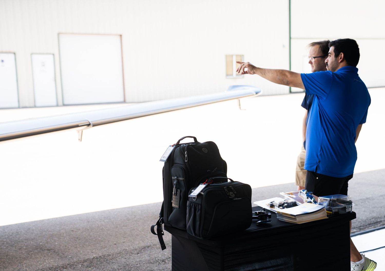 Aviation training session with equipment and instructional materials laid out on tables.
