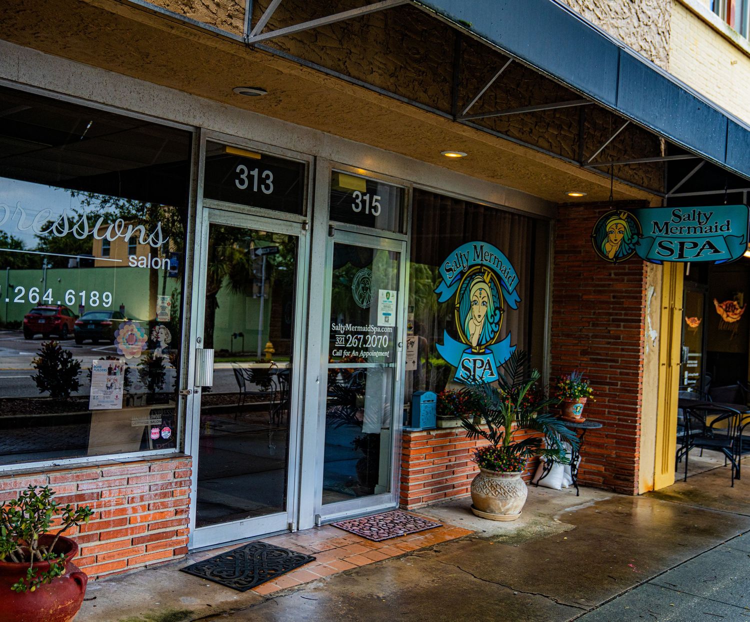 Commercial building facade with brick details and numbered storefronts.