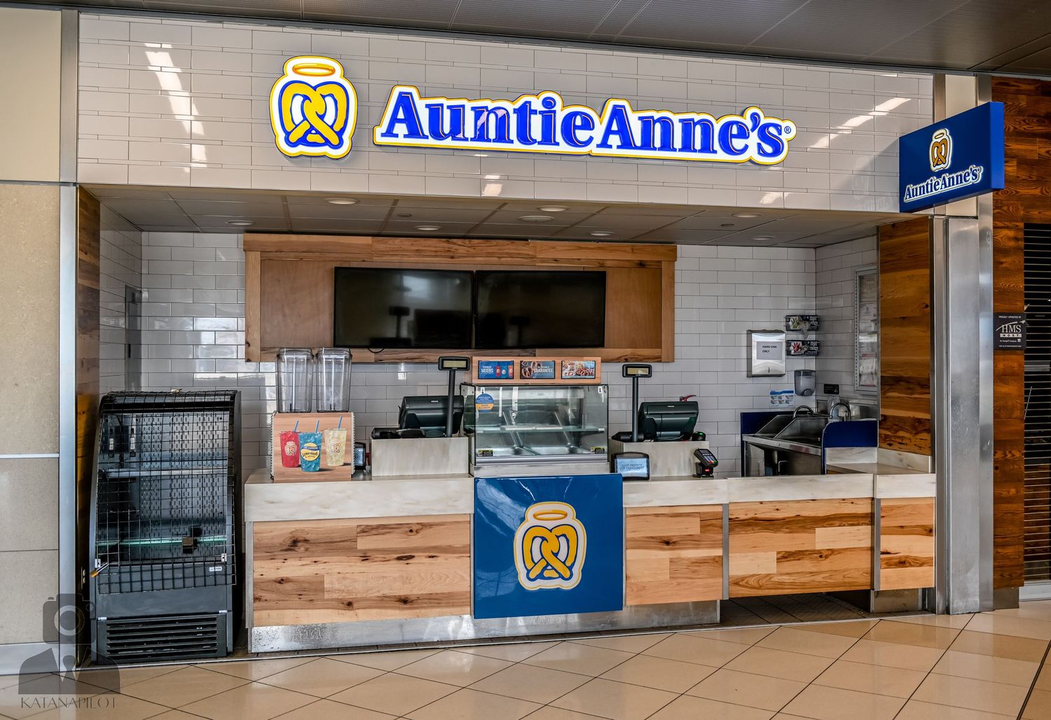 Auntie Anne's pretzel shop storefront with wooden accents and blue logo signage.