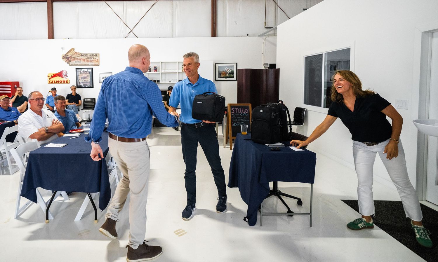Training session participants engaging with presentation material in a converted warehouse space.