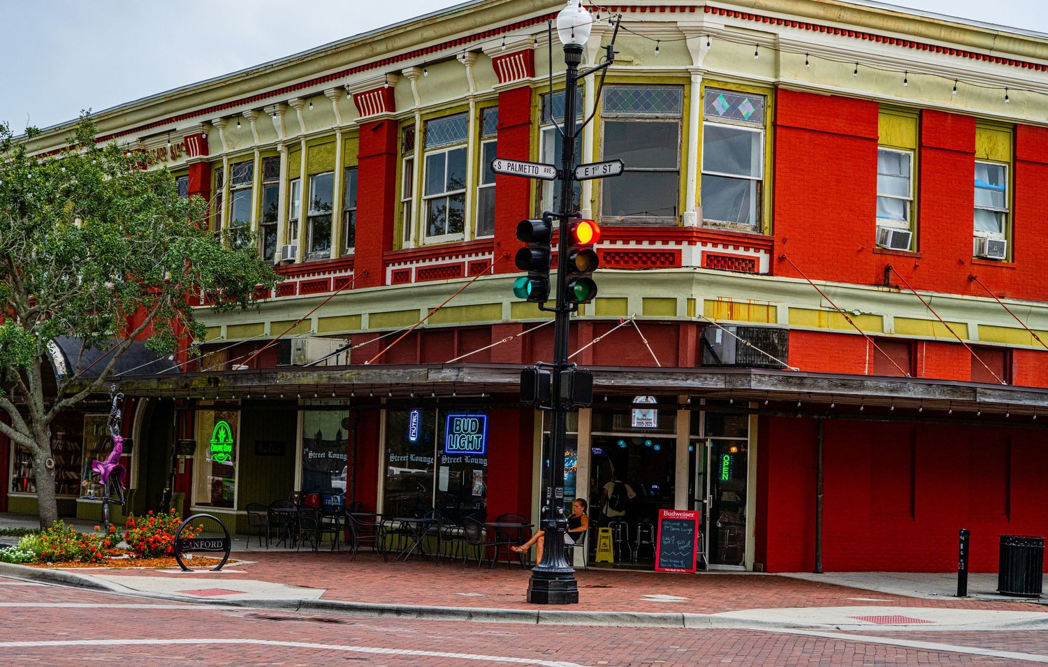 Corner view of a historic red brick commercial building with decorative architectural details.