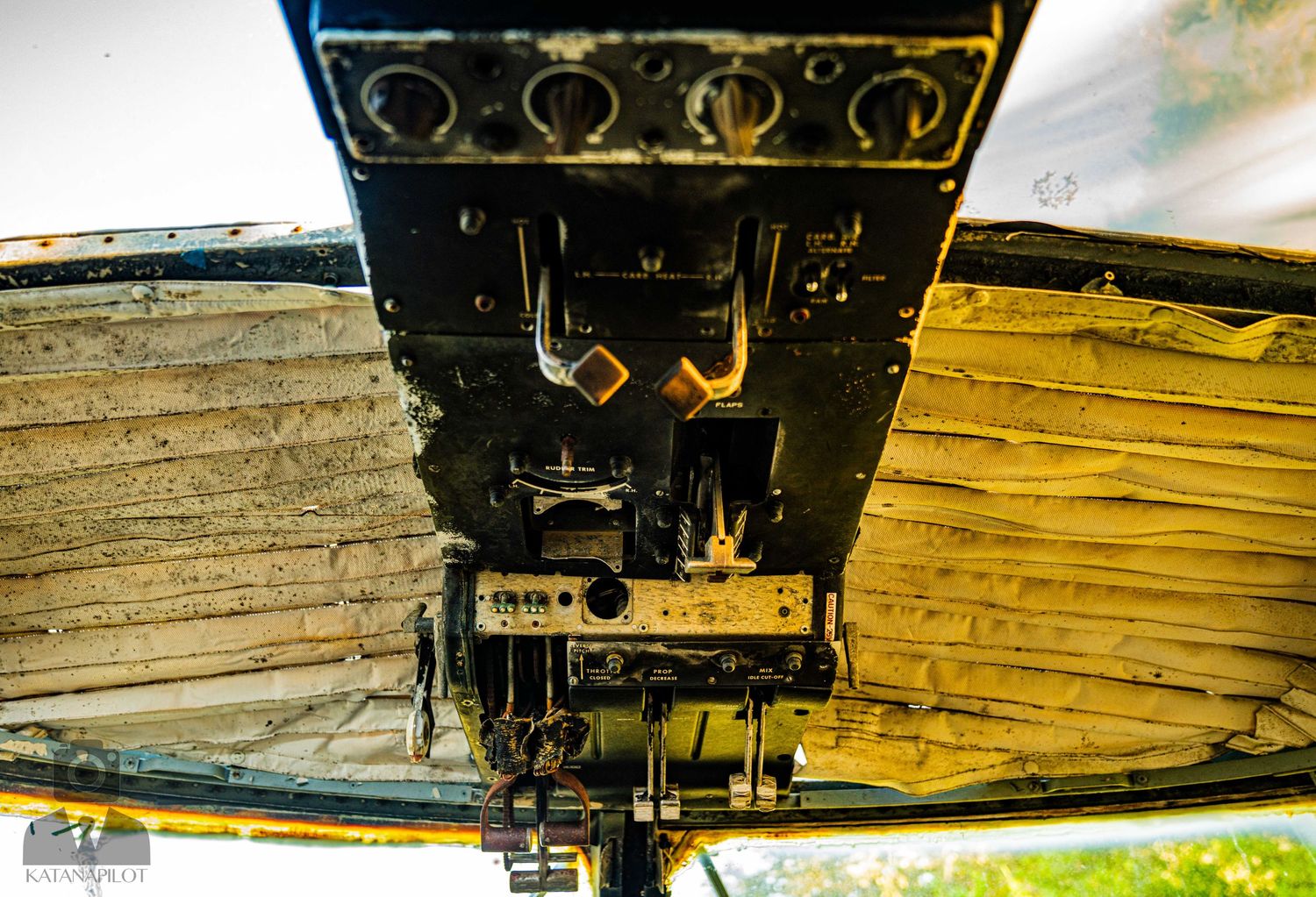 Detailed view of vintage aircraft control panel with multiple gauges and switches.