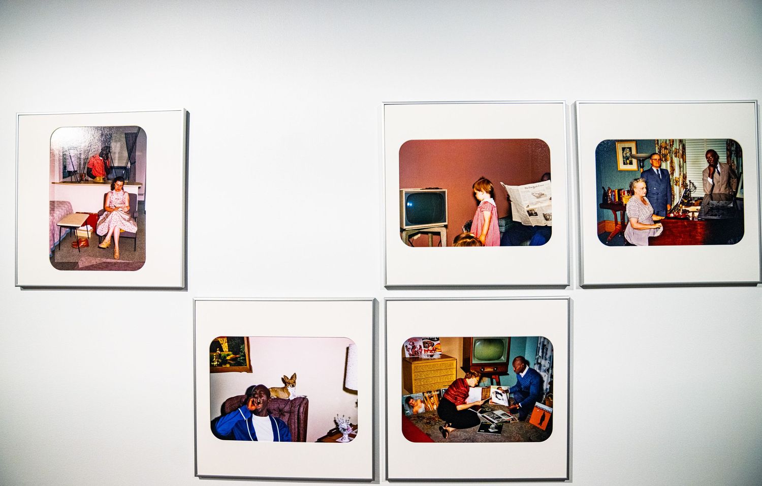 Gallery wall displaying a series of framed photographs in a museum setting.