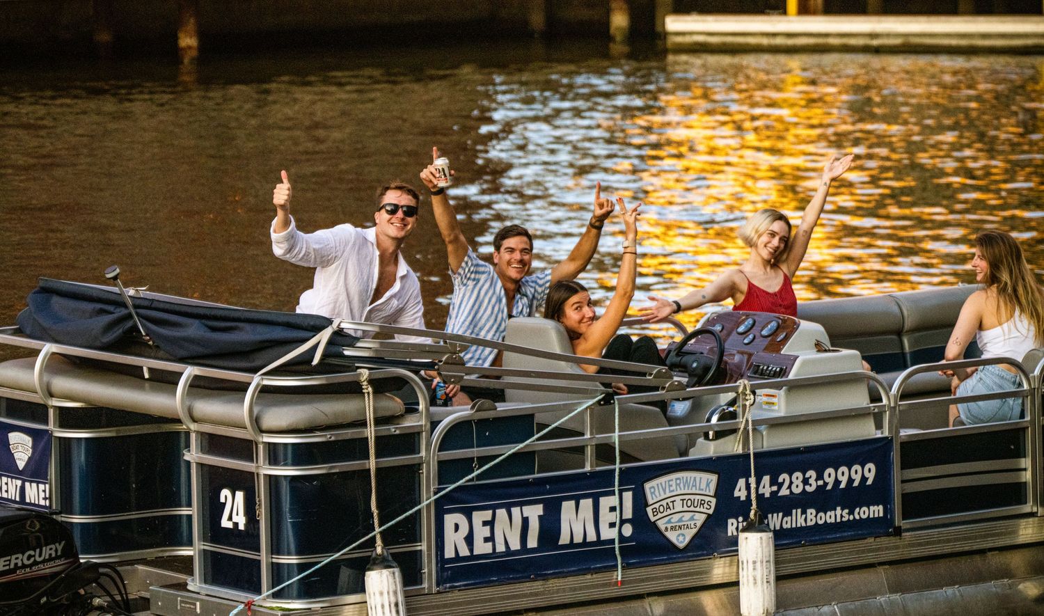 Small rental boats floating on calm water with American flag and 'Rent Me' sign visible.