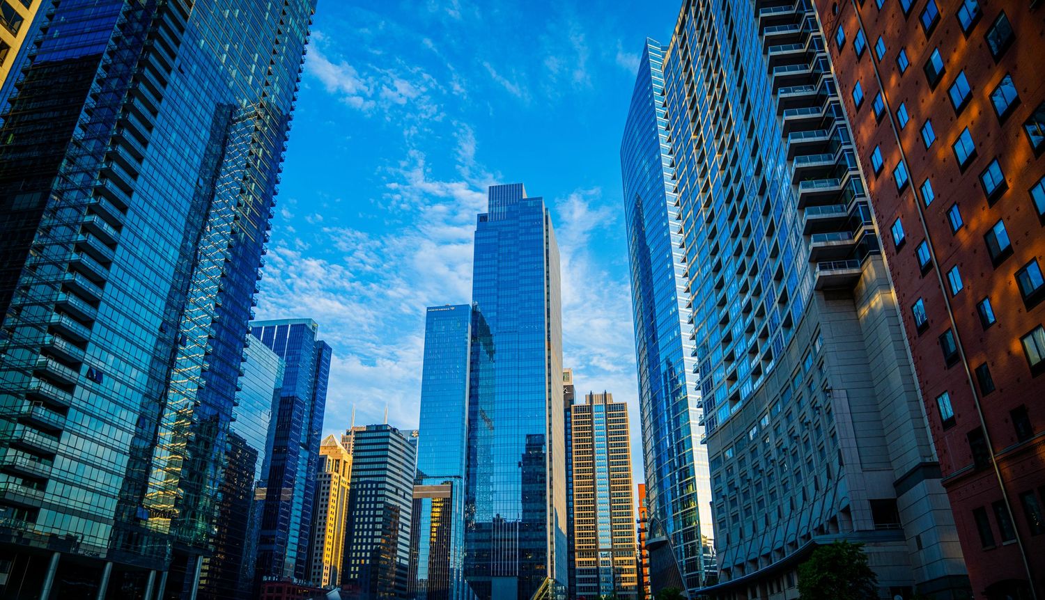 Contemporary architecture of Chicago's downtown featuring glass and steel skyscrapers against bright sky.