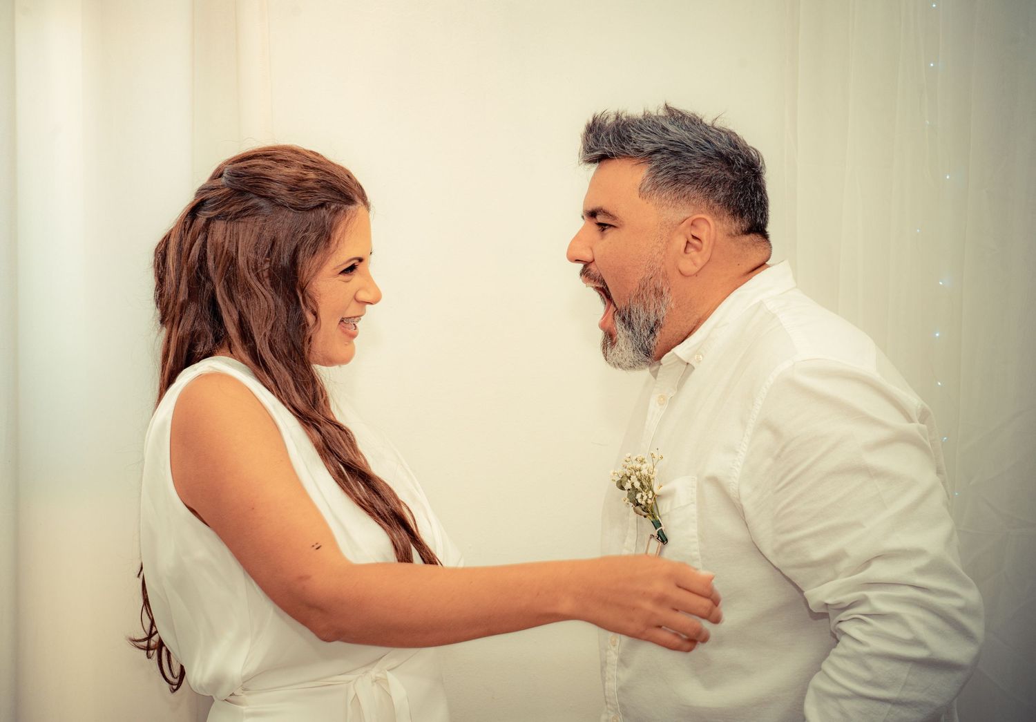 A series of romantic wedding photos showing tender moments between a couple in white attire against a light background.