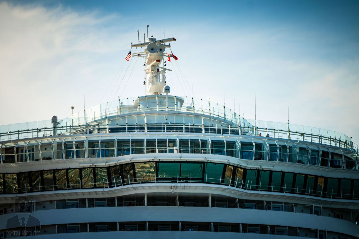 A panoramic sequence showing a white cruise ship deck with railings against a blue sky and ocean background.