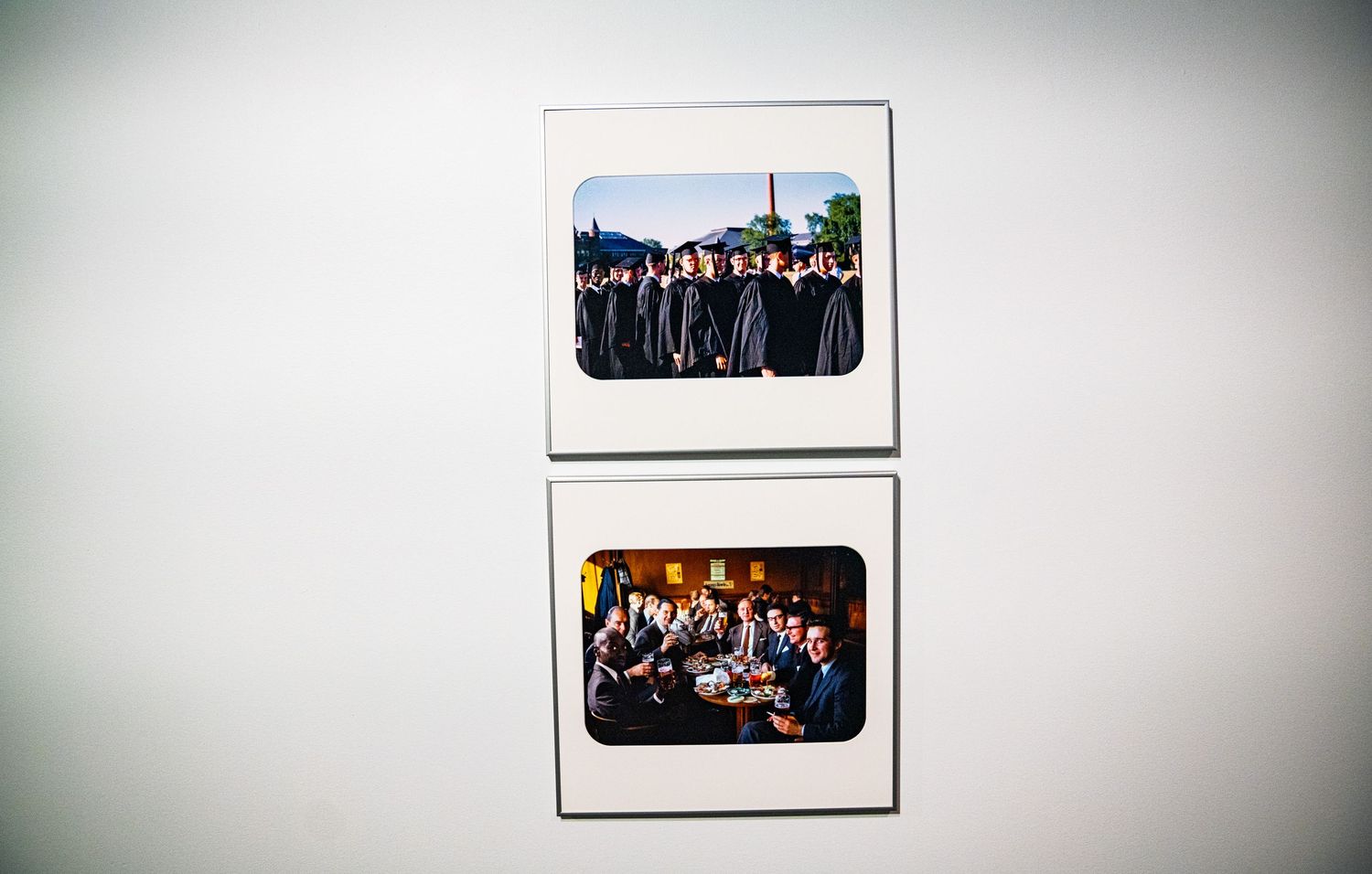 Minimalist gallery wall with spaced photographs in matching white frames.