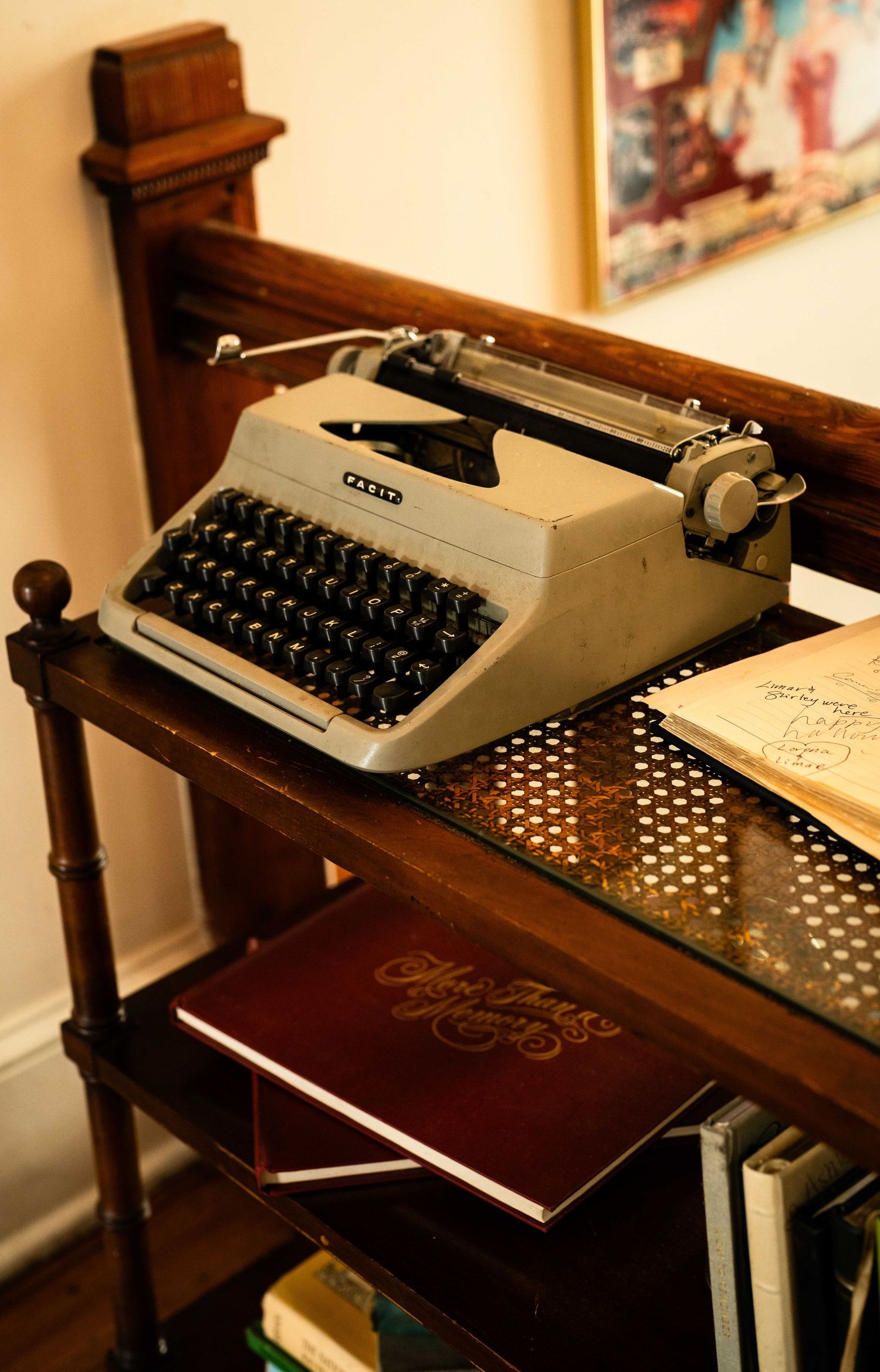 A vintage typewriter sits on a wooden desk with books nearby, creating a nostalgic writing scene.