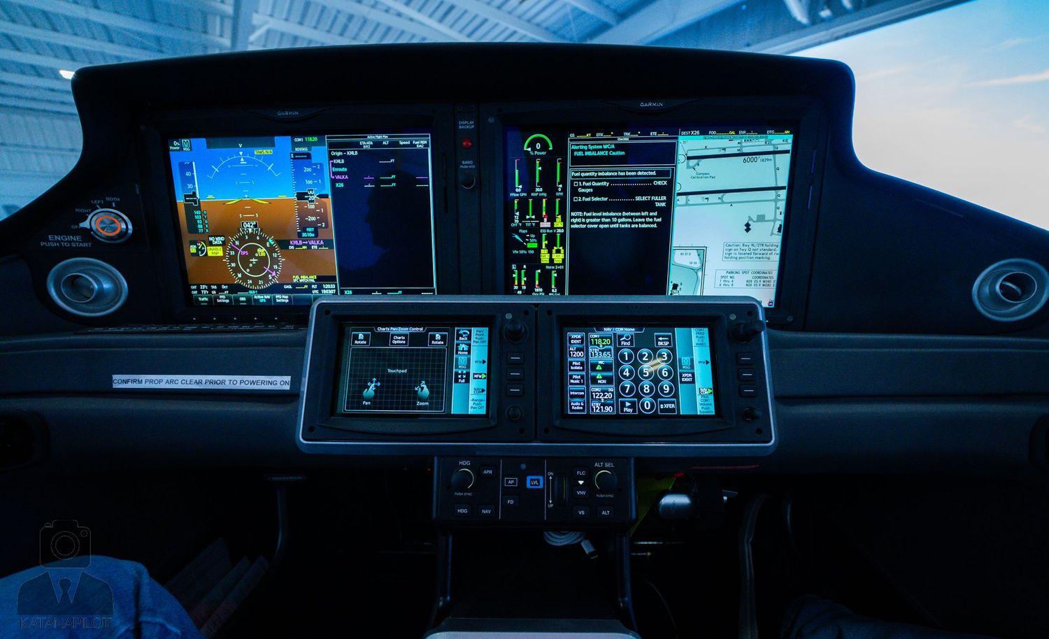 High-tech cockpit dashboard with multiple digital displays showing navigation and flight data.