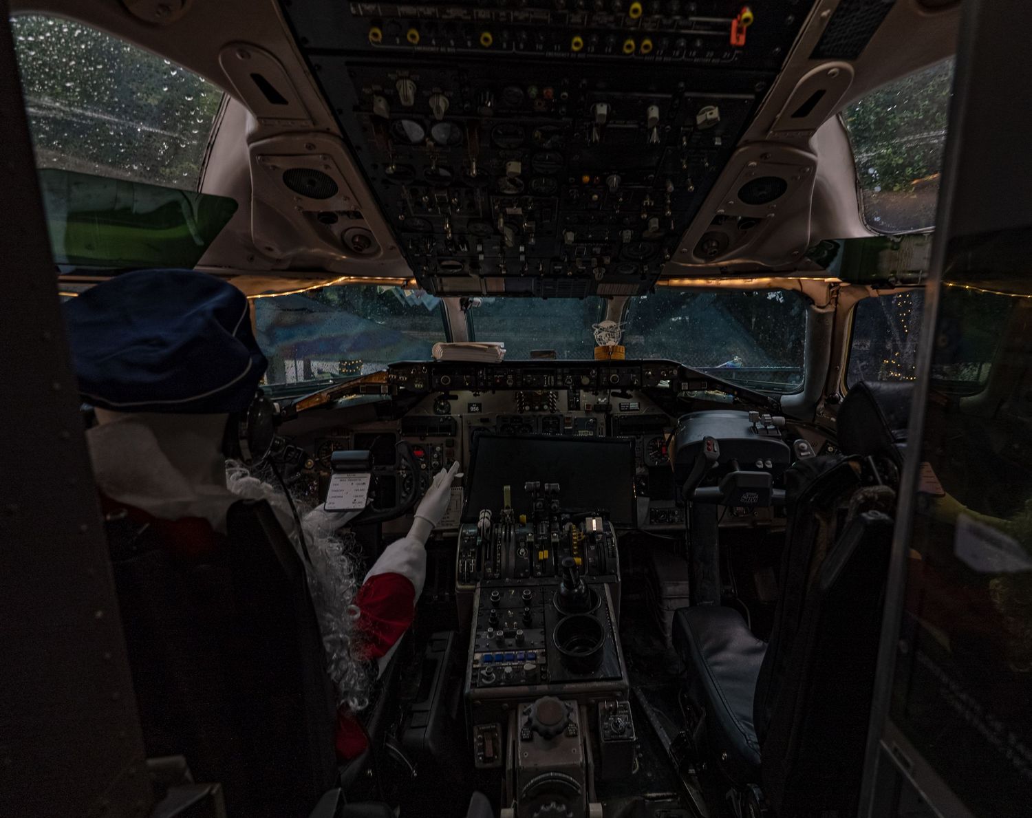 Aircraft cockpit control panel with multiple displays and instruments.